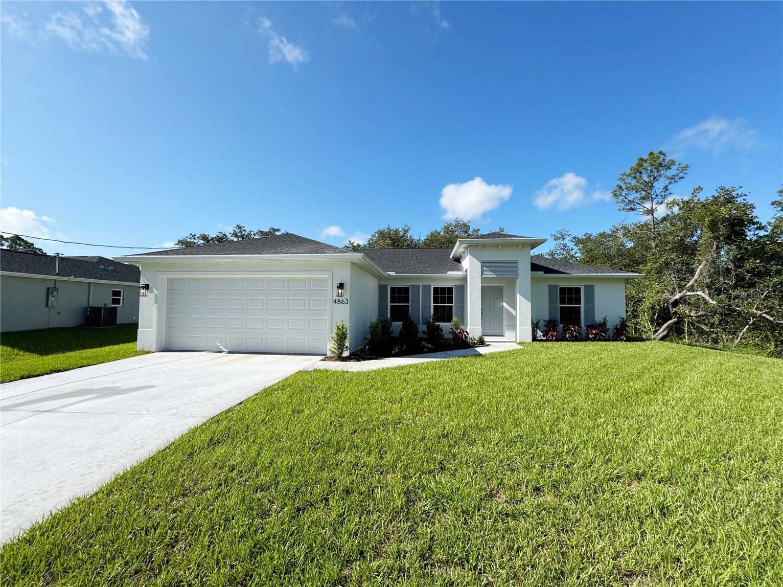 One or more photo(s) has been virtually staged. Beautiful New Construction Home Available Now! Everything is Included and Everything is Upgraded! Starting with an open, split floor plan with vaulted ceilings, this home has Hurricane Impact, insulated, low e windows, full overlay cabinets, stainless steel kitchen appliances, quality stone countertops and window sills, porcelain tile throughout, 30-year shingles, 3 zone sprinkler system, screened lanai, brand name plumbing and electrical fixtures, fully sodded and landscaped. This home has been built to keep insurance, maintenance and utility costs low. Preferred lender is offering up to $1,500 in closing cost assistance! Come see this New Home today! Take a tour through of one of our Beautiful Homes: https://youtu.be/SFsL-Aell24