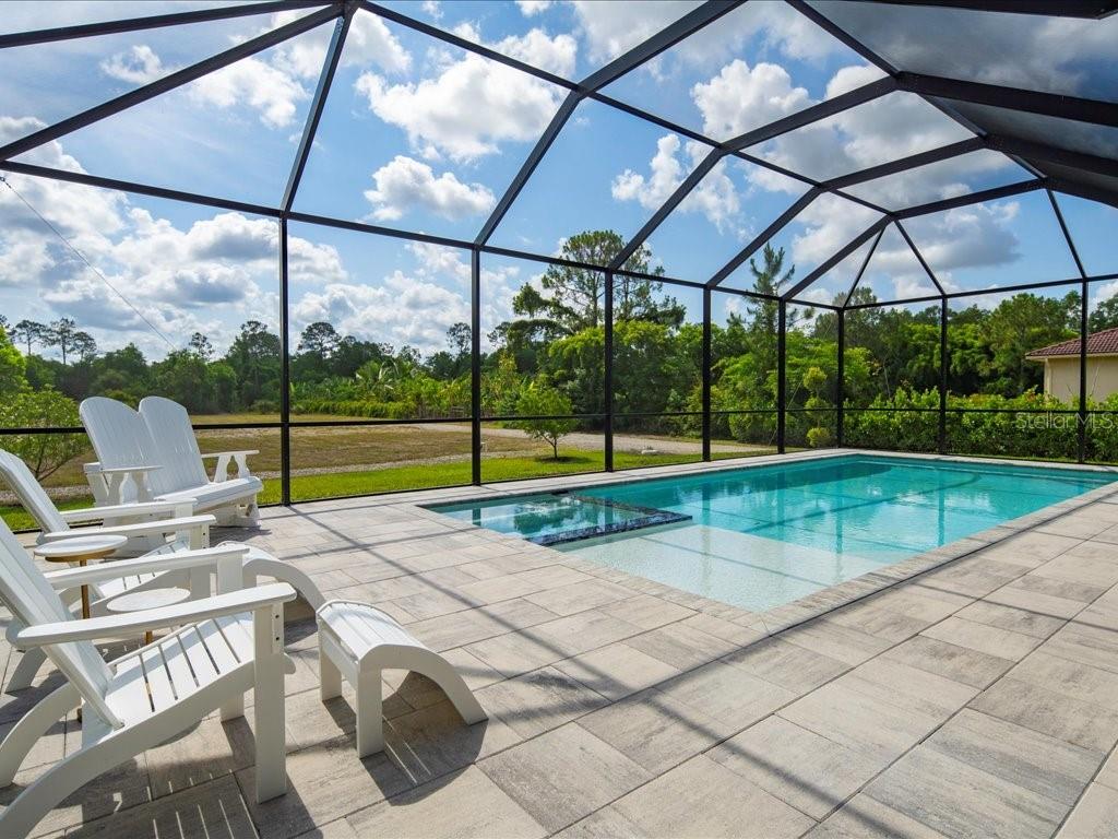Significantly Reduced * Pride of ownership radiates from this immaculately maintained and Upgraded four-bedroom plus Flex space / Den / Dining area, three-bathroom Pool and Spa home. This Priced to Sell home has a practical layout with living room and family room areas close to each of the two Master Suites. The second Master suite is suitable for Multigenerational living or potential in-law suite. Numerous enhancements make it more desirable from when it was originally purchased new by the current owners, including custom shower doors for two bathrooms, new shower heads and toilets throughout and wood shelves for all closets. There are newer high quality fans, lighting, electric shades, and plantation shutters throughout additionally. There are Granite Countertops in all three bathrooms, where one Guest Bath serves also as a Pool Bath. LVF flooring was added throughout, with tile upgraded in bathrooms. The kitchen features elegant white wood cabinetry, stainless steel appliances and a breakfast nook overlooking the pool and deck areas. This 2018 built home is complemented by impact-resistant windows and doors to help ensure peace of mind. Crown Molding and tray ceilings throughout add a touch of sophistication. The spacious laundry room has 42-inch Cabinets, a sink, and an LG 2019 Washer and Dryer. A pool and spa by Jackson Pools have been lovingly added in 2021, turning this residence into an oasis. This Golden Gate Estates home offers essential comforts for inspired living, including a GENERX generator, a whole house reverse osmosis (RO) system, a sprinkler system, and gutters. The brick paver driveway is lined with Clusia for additional privacy. This home offers peace, tranquility and convenience, with easy access to essential stores and amenities; so as to fully enjoy the Southwest Florida Lifestyle in addition to our famous SWFL Sunsets. Home is located in the highly coveted Gulf Coast High School district. There is plenty of room for Guest House / Workshop / Horse Stalls, RV, Boats, Trailers, and all your Toys, with no HOA fees or Condo Commandos in the Golden Gate Estates neighborhoods. Horses are OK. Floor plan, features sheet and survey are available. Bring your offer today on this Priced to Sell Home. Property Address is 836 14th St SE, Naples FL 34117 for GPS. There is a yard sign to help locate. HT267
