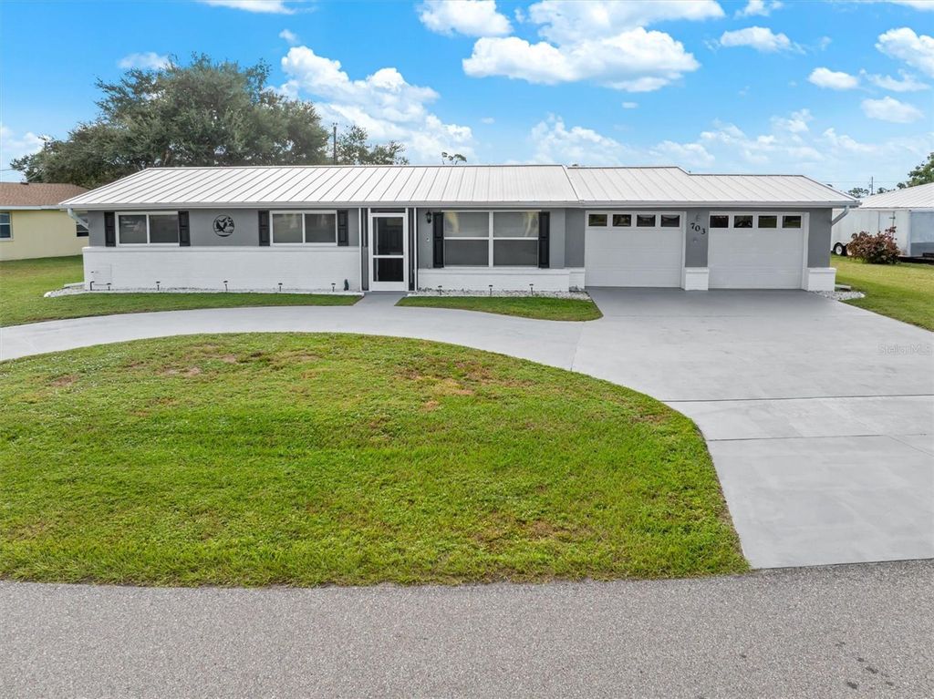 Photo of 703 Spring Lake Boulevard NW, Port Charlotte, FL 33952 (MLS # C7515906)
