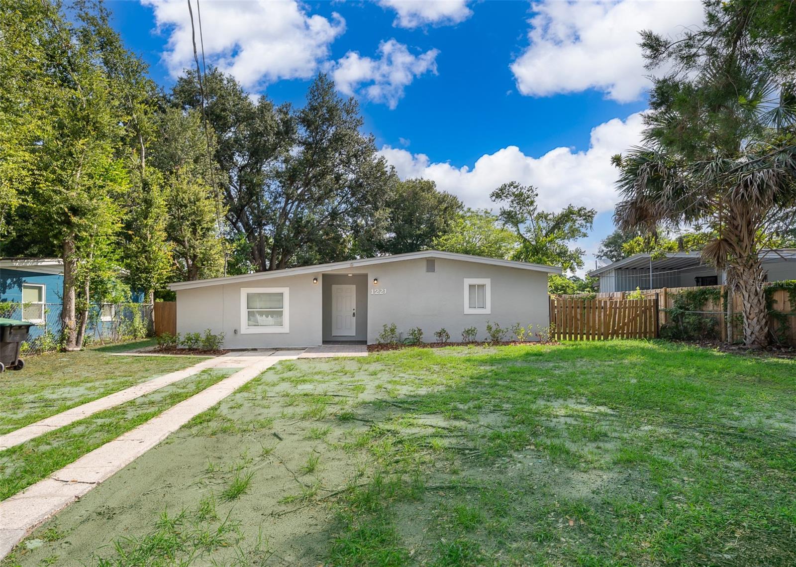 Comfortable and filled with natural light, this fully remodeled property is move-in ready. It features a charming yard with trees and lush greenery—perfect for outdoor activities, children, or pets. Enjoy the screened rear porch, ideal for relaxing in the evening breeze. The air conditioning ducts have been recently replaced. Public transportation is just a 5-minute walk away, and Orlando International Airport is only a 30-minute drive. The property is also surrounded by three major local parks—Ivey Lane Park, Burnett Park, and Willows Park—all just 5 minutes away by car. Near shopping centers, restaurants and more.