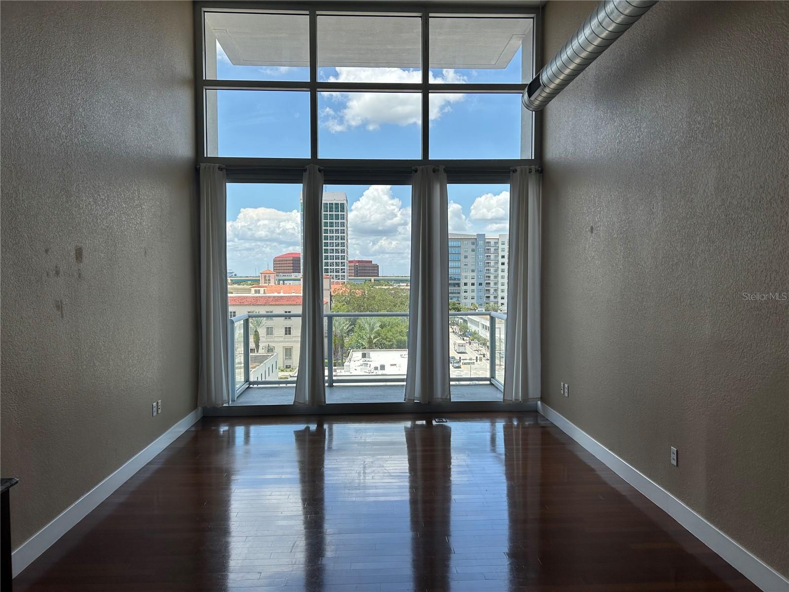 Live in the heart of downtown Orlando in this stylish studio at The Vue! Located on the 7th floor, this unit offers stunning city views and unbeatable access to the building's premier amenities - right on your floor! This studio unit features an open-concept with floor-to-ceiling windows, 1 full bathroom, in-unit washer and dryer for ultimate convenience, modern kitchen with sleek finishes, and gorgeous hardwood floors. The Vue offers incredible amenities including a state-of-the-art fitness center, a resort-style pool and sun deck, an elegant club room and lounge area, along with 24-hour concierge and security. Step outside and you're just a short walk to Lake Eola, coffee shops, restaurants, bars, and everything downtown Orlando has to offer! Don't miss the chance to live in one of Orlando's most sought-after addresses. The Vue offers luxury, convenience and lifestyle all in one.