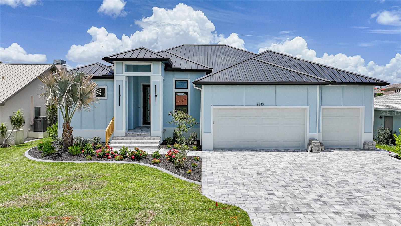 Introducing a rare opportunity to own a brand-new, custom-built waterfront estate that flawlessly combines contemporary design, refined craftsmanship, and the relaxed sophistication of Southwest Florida living. Nestled on a quiet canal in one of Punta Gorda’s most desirable neighborhoods, this 3-bedroom + den, 3-bathroom residence offers over 2,598 sq ft of meticulously curated living space—designed to impress at every turn. From the moment you arrive, the home's striking curb appeal and attention to detail signal that this is no ordinary build. Step inside and be welcomed by an open-concept floor plan adorned with wide-plank tile flooring, exquisite tray ceilings, faux wood beams, and custom shiplap features that echo coastal elegance. The heart of the home is the designer kitchen—outfitted with Café Professional stainless-steel appliances, quartz countertops, soft-close cabinetry, and a gas cooktop—flanked by a butler’s pantry, wet bar, and wine refrigerator for effortless entertaining. A wall of zero-corner sliding glass doors opens completely to the outdoor living area, blurring the lines between interior and exterior in true Florida fashion. Retreat to the expansive primary suite, where private pool access, a custom wood closet system behind 8-foot solid doors, and a spa-like bath with dual shower heads and a rain shower head, with quartz finishes that create a personal sanctuary. The thoughtful split-bedroom layout provides comfort and privacy for guests, with the second bedroom featuring an en-suite bath, and the third offering direct access to the pool and shared access to the cabana-style pool bath. Step outside to your private tropical resort—a fully fenced backyard anchored by a heated, saltwater pool adorned with iridescent glass tile, powered by state-of-the-art Pentair equipment. Entertain in style under the extended covered lanai complete with a fully equipped outdoor kitchen (grill, sink, refrigerator), and refresh with the outdoor shower after a day on the water. A 36x10 concrete dock with pavered walkway offers quick boating access, making this home a dream for water enthusiasts. Additional luxury features include: *Three-car garage with epoxy flooring *Custom wood accents and high-end finishes throughout *TV mounts pre-installed in multiple rooms *Quartz surfaces in kitchen, all bathrooms, and laundry *Rain gutters, garbage disposal, and fully landscaped grounds. This home is more than move-in ready—it’s a move-up in lifestyle. Every inch was crafted with the discerning buyer in mind, combining architectural beauty with practical luxury. Whether you're seeking a serene retreat or an entertainer’s paradise, 2815 Coral Way delivers an elevated waterfront experience without compromise. Schedule your private showing today and experience Punta Gorda luxury at its finest.