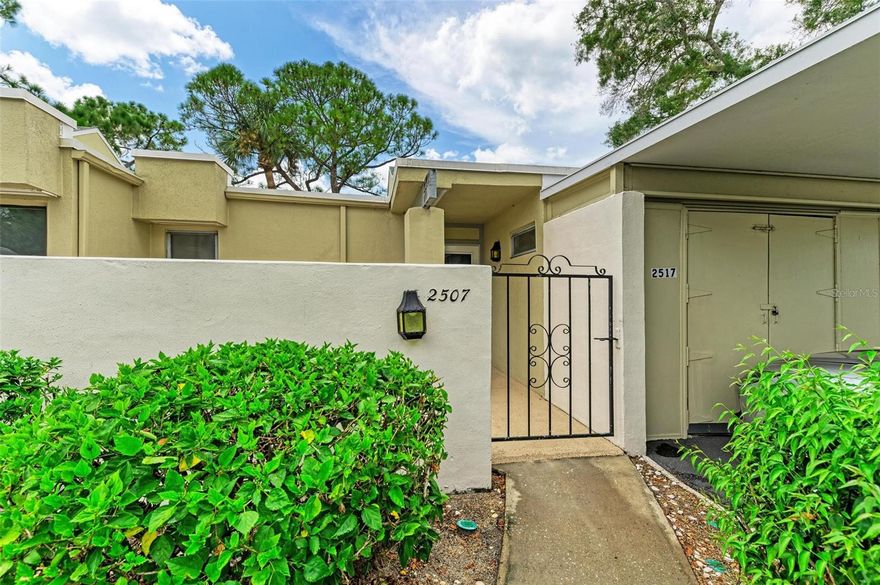 What a wonderful opportunity to love living life in highly sought after Meadowlake in the peaceful golfing community of The Meadows in this light and bright newly renovated villa. As you enter through your private Gated Courtyard, you’re immediately taken back by the charm of this spacious corner unit and the fresh open feel of the expansive living room with high ceilings, fresh paint, and neutral luxury vinyl plank flooring. Entertainment is a breeze with Sliding glass doors in every room that open to the immense screened private lanai space that wraps around the kitchen, living room and primary suite where natural light abounds for the ultimate Florida lifestyle. Enjoy your brand-new designer kitchen with Sparkling Quartz counter tops, soft close white shaker cabinets with transitional brushed nickel hardware, stunning neutral backsplash, stainless appliances and lighted water flow faucet.  The primary bathroom has also received a fresh renovation that includes a new tub with designer tile and has a large new soft close vanity with quartz counters that is separate from the rest of the bathroom amenities allowing for privacy and space. The guest bathroom has also had a fresh makeover. This unit also features an indoor laundry room and private covered carport with a personal outdoor storage room for convenience. The meadows is known for its beautiful nature rich surroundings with plentiful wildlife, nature trails with sprawling green spaces. Residents can relax in one of the two heated community pools and enjoy The Meadows Country Club which offers amenities for an active lifestyle including a clubhouse, three 18-hole golf courses, social activities, and tennis. Membership opportunities are available, but membership is not required. Fitness Center and Clubhouse pool are included. This location is a short drive to the Gulf beaches, St. Armands Circle, and the UTC mall.