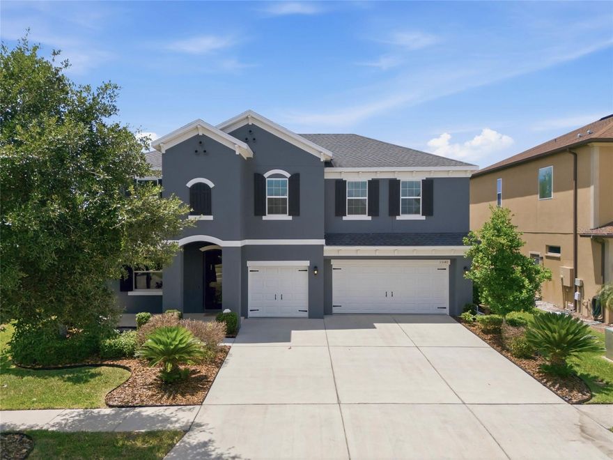 One or more photo(s) has been virtually staged. Welcome to Watergrass living where space, layout, and location come together in one of Wesley Chapel’s most sought-after master-planned communities! This 5-bedroom, 3.5-bath home with a 3-car garage offers a functional, high-demand floor plan designed for both everyday living and effortless entertaining. From the moment you walk in, you’ll notice the expansive open layout with wood-look tile flooring throughout the entire first floor—giving you durability, style, and easy maintenance. The heart of the home is the oversized kitchen, featuring 42” white cabinetry, quartz countertops, and a seamless flow into the living and dining areas—perfect for hosting, daily routines, or keeping everyone connected. The primary suite is conveniently located on the first floor, offering privacy and a true retreat feel with a tray ceiling, spacious layout, and an ensuite bath complete with dual vanities, quartz countertops, a soaking garden tub, and a separate walk-in shower. Upstairs, the home opens up into a large bonus/game area, ideal for movie nights, a playroom, or second living room, plus four generously sized bedrooms that give flexibility for guests, office space, or multi-generational living. Recent updates include upstairs air handler replaced in June of 2024 and exterior repainted in 2025. Step outside and you’re not just buying a home—you’re stepping into the Watergrass lifestyle. Residents enjoy access to a resort-style clubhouse, fitness center, playgrounds, scenic walking areas, and a Jr. Olympic-sized pool, all within a beautifully maintained community with lush landscaping and signature architectural details. Location-wise, this is exactly where people want to be. Conveniently located by The Shops at Wiregrass, Tampa Premium Outlets, AdventHealth Wesley Chapel, and access to Interstate 75 and Interstate 275. If you’ve been waiting for a move-in ready home with space, smart layout, and strong value in Wesley Chapel, this one checks all the boxes!