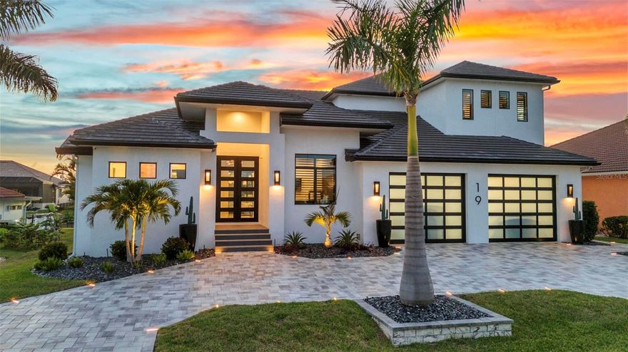 Welcome to 19 Sabal Drive, a striking luxury residence in Punta Gorda Isles where cutting edge design, and waterfront living come together. Positioned just five lots from Charlotte Harbor, this custom home offers exceptional Gulf access, setting the stage for an unparalleled coastal lifestyle.Built for both beauty and durability, this two-story home spans 3,910 square feet and features 4 bedrooms, 6 bathrooms, a home office, an upper-level utility room, a 3-car heated and cooled garage, and a dedicated exterior-access storage room. Hurricane-rated impact glass throughout including custom garage doors.High-end finishes like 24”x48” porcelain tile and custom black hardwood floors add depth and sophistication.At the center of the home is a chef’s dream kitchen equipped with Sub-Zero refrigeration, a JennAir micro/oven, induction stove top, and dishwasher a double-faucet 60" sink, no seam quartz counters and backsplash and sleek custom cabinetry. Tucked behind the kitchen a butler’s pantry offers tons of extra prep space, a True commercial-grade double glass-door cooler, modern cabinetry, and a wall-mounted hydration station. For entertaining, the wet bar includes True black stainless under-counter coolers and ice maker for seamless hosting.The wine room, styled with dramatic black hardwood, houses up to 240 bottles in a climate-controlled showcase.
Step outside to your private resort-style retreat, featuring an oversized pool and spa surrounded by a custom porcelain deck with hidden drainage. The outdoor kitchen boasts weatherproof cabinetry, a 48" sink with disposal, a built-in grill, oversized burner, 4,000 CFM vent hood, and 2 granite fire boxes. LED rope lighting on the pool cage and Hunter Douglas auto blinds on 10' sliders elevate every moment spent outdoors.For boating enthusiasts, the property includes a 30,000 lb lift with auto cover for a 40' boat, dual jet ski lifts, and an expansive dock.
Additional upgrades throughout the home include a central air fragrance system, six Kohler Veil smart bidet toilets, electric fireplaces, Euro-style outlets and switches, high-end lighting fixtures, a 7-zone irrigation system, built-in power washer, tailored wall treatments and thumbprint entry locks. The garage doubles as a fitness zone with professional equipment and epoxy floors, while the exterior-access storage room offers ample space for tools and recreational gear. Smart home integration brings convenience and comfort with control over the 9-zone Sonos system, lighting, shades, HVAC, security, and more, all from your phone.
This isn't just a home it's a masterpiece of innovation, luxury, and lifestyle on the water.