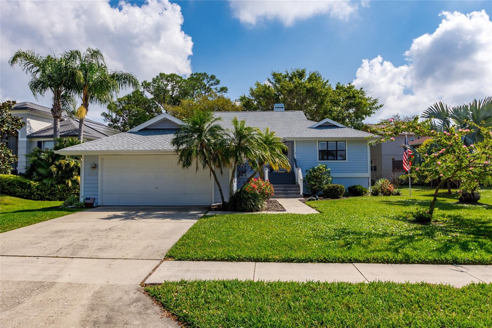 PRICE ADJUSTMENT! Charming Key West style home located in beautiful Pointe Alexis –Truly a “Hidden Gem” of Tarpon Springs! This newly remodeled home has 1,914 square feet of living space which includes 3 bed/2 bath, Living/Dining combo with vaulted ceiling, and 2 car garage. Features include a spacious eat-in kitchen, with stainless steel appliances, marble countertops with large farmhouse sink, plenty of custom cabinetry, large kitchen island with seating and wine cooler. Large windows and slider which allow a lot of natural light in Living/Dining room area. Also includes engineered flooring throughout and updated tile in bathrooms and laundry room, ceiling fans, wood burning fireplace, custom shades with remotes and laundry room with sink.
Spacious Master Suite with custom walk-in closet and an ensuite bathroom with double vanity, marble countertop, garden tub and separate glass shower. Two other bedrooms for family, guests or an office. Lanai overlooking a tranquil pond was made for entertaining and includes trex stairs and cable railing. This immaculate home and landscaping have been well maintained. Newer A/C and roof.
Tarpon Springs offers a Florida lifestyle along with the wonderful culture and true sense of community. Residents come together for all kinds of occasions including Frist Friday, music at Sunset Beach, the Boat Parade, the Art show on the Bayou, and more. Pointe Alexis is minutes to the beach of Fred Howard Park, Sunset beach, downtown Tarpon Springs and historical Sponge Docks; as well as many nearby marinas, and for those who love to golf there are many courses available nearby. Schedule a showing today!