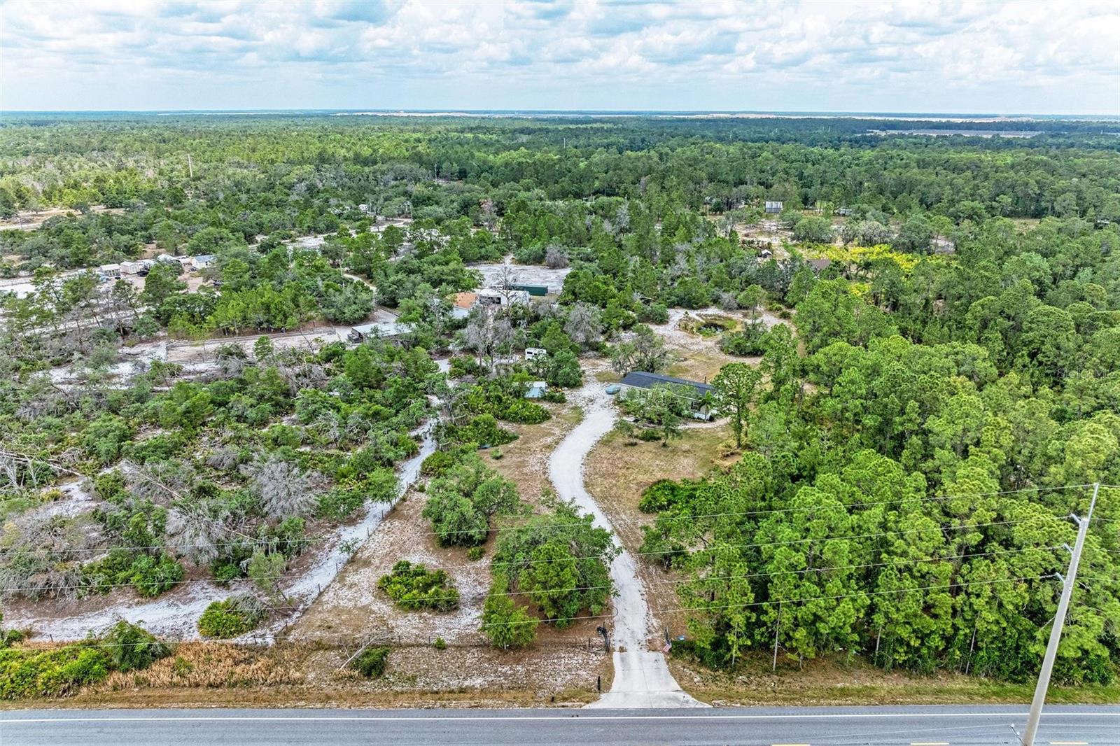 If you are looking for a beautifully updated home on 5 acres of high and dry land, this property is for you! Easily insurable and lender financing available! Set back off the road on 5 beautiful acres of agricultural land, this home offers tons of privacy, no deed restrictions and endless possibilities for your farming, gardening, horses, hobbies and more. With a NEW ROOF and BRAND NEW AC, this home offers 4 bedrooms, 2 bathrooms, plus an open floorplan. The kitchen features two-toned cabinets, an island with barstool seating, stainless steel range hood, built-in microwave, pendant lighting, window looking out to the backyard, and open sight lines to the living room and dining area. The primary bedroom is spacious and has a walk-in closet and ensuite bathroom with an updated vanity with two sinks, soaking tub, and a separate shower. The three additional bedrooms share a bathroom with a tub/shower combo and updated vanity. Additional features of this home include custom accent walls, new laminate flooring, new lighting and fans, indoor laundry room, storage shed, and a new high-end water filtration system. This property has a small pond, a fenced perimeter, mature trees, mango tree, and is not in a flood zone. If you are looking for acreage, peace and quiet, and endless possibilities to customize your land, this is your opportunity to create your own country paradise. All the big ticket items are NEW so you can start creating your dream homestead. Mineral rights convey to buyer! Schedule your showing today!