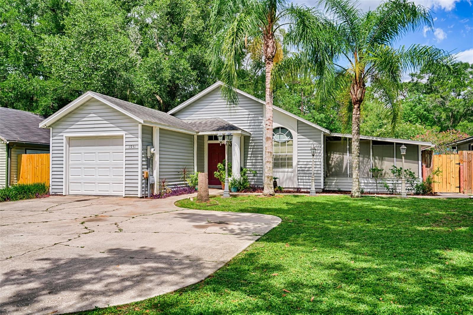Welcome to this well-maintained 3-bedroom, 2-bath home located in the Peppermill neighborhood. Offering 1,153 square feet of comfortable living space, this home features a living room with vaulted ceilings and durable flooring throughout—no carpet. The eat-in kitchen includes stainless steel appliances and a closet pantry for extra storage. The primary bedroom features a private bath with a walk-in shower, while two additional bedrooms share a full hall bathroom. Enjoy outdoor living with a screened Florida room, a privacy-fenced backyard, and a unique courtyard area complete with a tiki hut that has water and electricity. A large smokehouse/theatre, with its own 30 amp breaker, offers additional versatility with two smokers, sitting area and media space. There's also a small storage room off the smoker. The laundry area is located at the rear of the one-car garage. HVAC 2018. New water heater. Zoned for Chiles Elementary, Fort Clarke Middle and Buchholz High School. Conveniently located near I-75, the University of Florida, Shands Hospital, and shopping.