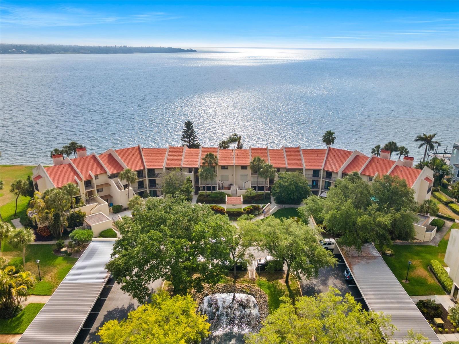 This coastal chic-inspired fully furnished 2nd floor unit located in Seapointe Terrace offers breathtaking views of Tampa Bay from the moment you enter. You will immediately notice all the updated finishes and pride of ownership. The open kitchen features ample cabinet and counter space; finished with a pantry closet. Located just off the kitchen is a half bath. Designed for both comfort and entertaining, the open-concept layout connects the kitchen, living room, and dining area seamlessly to the 40ft balcony and open views of Tampa Bay. Both of the spacious bedrooms are paired with their own ensuite baths. One bedroom offers a versatile layout with a custom-built Murphy Bed and office desk. Relish in stunning Tampa Bay views and the dazzling LED-lit Sunshine Skyway Bridge from your private balcony… where dolphins and manatees are frequent visitors! The HOA dues cover nearly all homeowner expenses—including flood insurance, homeowners insurance, water, sewer, trash, exterior maintenance, and amenities. Seapointe is a sought-after waterfront community offering access to a waterfront pool, tennis, pickleball, a clubhouse, kayak launch with storage, and the skyway trail for outdoor exercising. With easy access to I-275, downtown St Petersburg is just a 10-minute drive and the Tampa Airport only 25 minutes away. It is only 10 minutes to Fort DeSoto Park and area beaches. Walking distance to 2 marinas, Maximo Park, and Sky Beach Resort.
