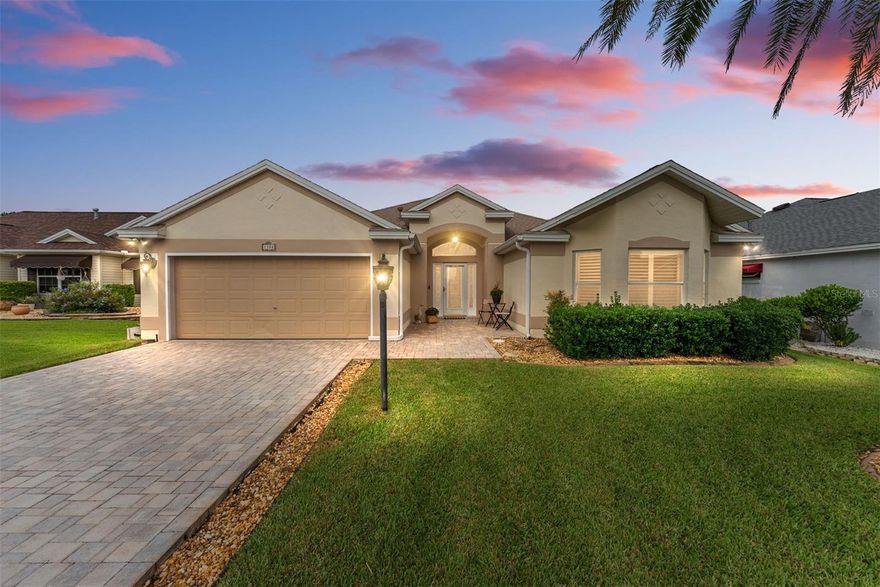 This home checks almost every box!  You can find this lovely 3-bedroom/2-bath /2-car garage (Lantana designer home) with a private fiberglass pool with solar heating and a triple fountain on a quiet cul-de-sac street in the highly desirable Village of Santiago.  BOND IS PAID.   This home is in a great LOCATION with access to the Santiago Recreation Center, The Savannah Center, The Villages Hospital, Spanish Springs & Lake Sumter town squares, and the  Nancy Lopez Legacy Country Club.  The home has a concrete block and STUCCO EXTERIOR, the architectural shingled ROOF was REPLACED at the end of 2019.  The exterior has a paver driveway/walkway, and mature landscaping.
You will enter through the lead glass front door with matching sidelights and an arched transom overhead for additional natural light. Once inside the spacious foyer, you will immediately notice the 10' vaulted ceilings, beautiful doorway arches, and the diagonally set CERAMIC TILE FLOORING (no carpet) in the home. Blinds and ceiling fans throughout. The kitchen includes oak wood cabinets, granite backsplash, beveled edge granite countertops, a large GRANITE PENINSULA with a raised pony bar, closet PANTRY, STAINLESS STEEL appliances, Solid wood RAISE PANEL CABINETS, and an electric cooktop with dual oven and microwave (line already installed for GAS HOOKUP). Off the kitchen is a spacious laundry room with a washer/dryer, utility sink, and upper cabinets for extra storage space. The laundry room can also serve as a "home office area" with a desk included.

The master bedroom offers ample space, diagonally set ceramic tile flooring, vaulted ceilings, and sliding glass doors leading to your oversized screened lanai/pool area. The ensuite bathroom includes a GRANITE countertop DUAL SINK VANITY, bathtub, separate shower, private water closet, and large walk-in closet.  

This split bedroom design has two generously sized guest bedrooms located just of the front foyer. The front guest room with its bay window and plantation shutters is ideal for a den or bedroom.  The guest bathroom located off the foyer includes a GRANITE COUNTERTOP vanity and shower. 

Moving towards the rear of the home are (2) sets of sliding glass doors that lead into the enclosed, air-conditioned Florida room (paver flooring) with doors that lead into your oversized, screened lanai/pool area. Plenty of space to build an outdoor jacuzzi, kitchen, or sauna!  Other upgrades – The HVAC was replaced in 2022 including a new smart thermostat and centralized filtration.  The lanai/florida is under air. 3 SOLAR TUBES, natural gas dry and water heater, solar-powered attic fan, and pull down attic stairs.   The sale of this home also includes a 2012 Yamaha Drive Gas Golf Cart with less than 600 hours, enabling you to go anywhere in the Villages at will.  BOND IS PAID, CDD – 391.77 annually.