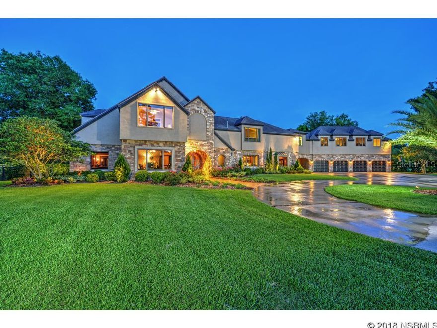 Remarkably exquisite riverfront retreat tucked away on the Tomoka River surrounded by 5 acre estate homes. Completely fenced and gated. The stunning outdoor is designed for grand entertaining offering an award winning infinity pool and spa, resort style outdoor kitchen with all the bells & whistles for the home chef. The expansive covered veranda offers a beautiful fireplace, heating system for those cool nights, flat screen TV, and remote control screen panels that encloses veranda for privacy and keeping children/pets from pool. The pool bath is beautifully designed with walk-in shower. Enjoy your private dock, your sandy beach on the Tomoka River, and your very own illuminated tennis court. Inside, the epicurean kitchen has been custom designed offering stainless steel Sub Zero and Viking appliances, built-in Miele coffee system, refrigerated drawers, spacious pantry, crystal light fixtures, fireplace, and marble flooring.  The stylish owners retreat adjoins a sitting room with double sided fireplace, two walk-in closets, elaborate bath with private sundeck, and adjoining fitness room or nursery.  Above the 4 car garage you have a music room/game room and bedroom with bath. State of the art technology provides internet control over the entire home including security systems, cameras with 30 day security DVR, Sonos audio, Crestron video and lighting, WIFI thermostats, and all pool and spa features.