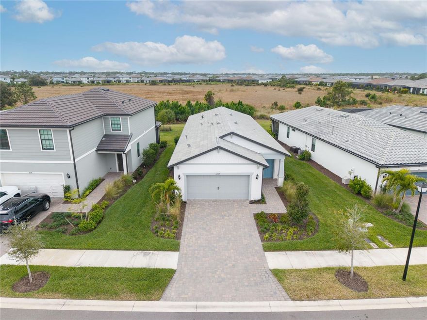 One or more photo(s) has been virtually staged. The best value single family home in Talon Preserve! Skip the wait for new construction and move right into this completed, upgraded Hallmark model in Talon Preserve, which sits on a premium preserve lot with sunset views and is just 9 minutes to Nokomis Beach! Move-in ready with impact windows and sliders, a gas range, tile floors (no carpeting), an extended lanai, an extended garage (4 extra feet longer than standard), dimmers, designer lighting, window treatments, an upgraded laundry room, and epoxy floors in the garage. The open-concept floor plan features 3 bedrooms and 2 bathrooms and abundant natural light. The kitchen includes an island, quartz countertops, soft-close cabinets, and seamless flow for everyday living and entertaining. The primary suite overlooks the preserve and offers a walk-in closet and a spa-style bathroom with a bench in the shower and a separate water closet.

Located just 9 minutes from Nokomis Beach and close to the Legacy Trail, Talon Preserve offers resort-style amenities including a resort-style pool, clubhouse restaurant and bar, fitness center, tennis, pickleball, bocce ball, splash pad, playground, dog park, and a guarded gate. Low HOA fees include lawn maintenance and there is NO CDD fee. Move right in and start enjoying the Florida resort lifestyle in Talon Preserve!