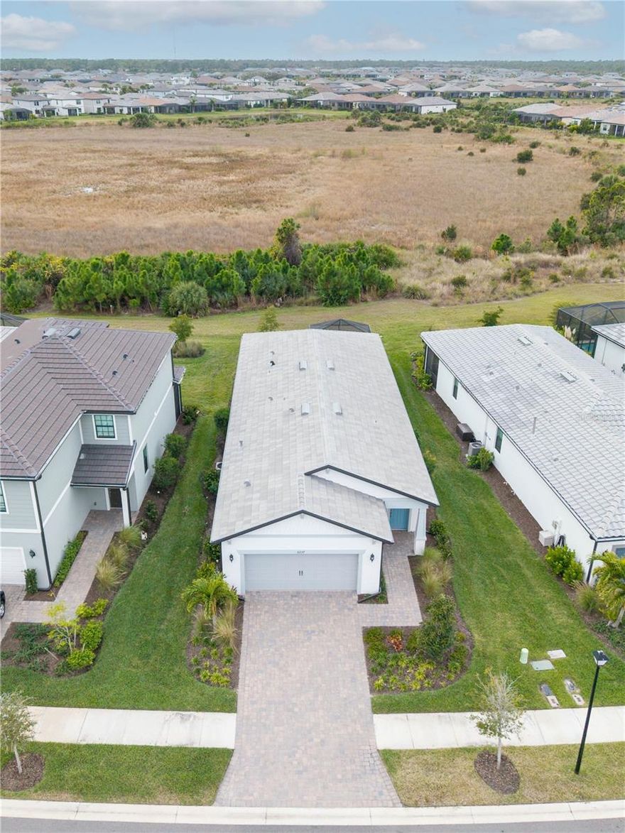 One or more photo(s) has been virtually staged. The best value single family home in Talon Preserve! Skip the wait for new construction and move right into this completed, upgraded Hallmark model in Talon Preserve, which sits on a premium preserve lot with sunset views and is just 9 minutes to Nokomis Beach! Move-in ready with impact windows and sliders, a gas range, tile floors (no carpeting), an extended lanai, an extended garage (4 extra feet longer than standard), dimmers, designer lighting, window treatments, an upgraded laundry room, and epoxy floors in the garage. The open-concept floor plan features 3 bedrooms and 2 bathrooms and abundant natural light. The kitchen includes an island, quartz countertops, soft-close cabinets, and seamless flow for everyday living and entertaining. The primary suite overlooks the preserve and offers a walk-in closet and a spa-style bathroom with a bench in the shower and a separate water closet.

Located just 9 minutes from Nokomis Beach and close to the Legacy Trail, Talon Preserve offers resort-style amenities including a resort-style pool, clubhouse restaurant and bar, fitness center, tennis, pickleball, bocce ball, splash pad, playground, dog park, and a guarded gate. Low HOA fees include lawn maintenance and there is NO CDD fee. Move right in and start enjoying the Florida resort lifestyle in Talon Preserve!