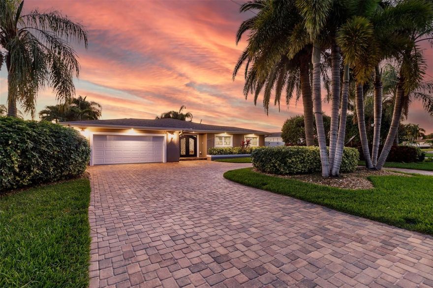 ~LIFE IS SHORT~BUY THE BEACH HOUSE~ You have found Paradise in this gorgeously remodeled 4 Bedroom, 3 bathroom Executive Waterfront home on an oversized lot with 50 foot of protected waterfront. The approach to this majestic home is via an extended circular paver driveway surrounded by mature tropical landscaping. Located on a quiet street near the end of Paradise Island you will find a meticulous residential retreat with private pool, spa and fifty foot of waterfront in your backyard. The owner has taken great pride in reconfiguring the interior layout of this home to include a grand entryway with a custom double steel & glass front door, raised roofline, coffered ceilings and a fully open planned home. The major professional remodel removed interior obstructions and literally raised the ceilings. Additionally, the rear portion of the house was floated and reconfigured to add additional square footage and to eliminate room transitions. The Primary suite, which overlooks the pool and intercoastal, boasts an all new oversized step in shower as well as a custom walk-in closet. The second bedroom, which could also be used as an office, has an ensuite bath with exterior pool access. Two additional bedrooms share a full bath and have wood plantation shutters. However it is the KITCHEN that will WIN YOUR HEART! This glamourous kitchen has excessive storage and features a huge center island with custom lighting and lots of counter space. Enjoy an additional coffee bar, wine chiller, new Kitchenaide appliances, microwave, induction stove, trash compactor and much more. Most appliances come with a 5yr warranty. Enjoy custom wood cabinets in the pantry/mud room in addition to a laundry room. You'll appreciate the complete electrical re-wire including a new panel, and a whole house gas generator that conveys with the home. Still more features include life-time roof shingles, new exterior and interior paint, fenced dog run, seawall with 2ft cap from 2008, new gas tankless WH, 5 ton HVAC 2015, new airducts throughout, new spray icynene foam insulation ( all old removed ), custom electric blinds, wood burning fireplace, custom garage floor, Electric Vehicle Charging station, new gutter system, gas heated spa and saltwater pool with lounge pad, tropical plants, new 16k LB lift and newer dock. Paradise Island is an attractive waterfront community on Treasure Island that is close to the beach, restaurants and downtown. 4POINT, WIND MIT,SURVEY AND ELEVATION CERT on file. Come see this beauty today!