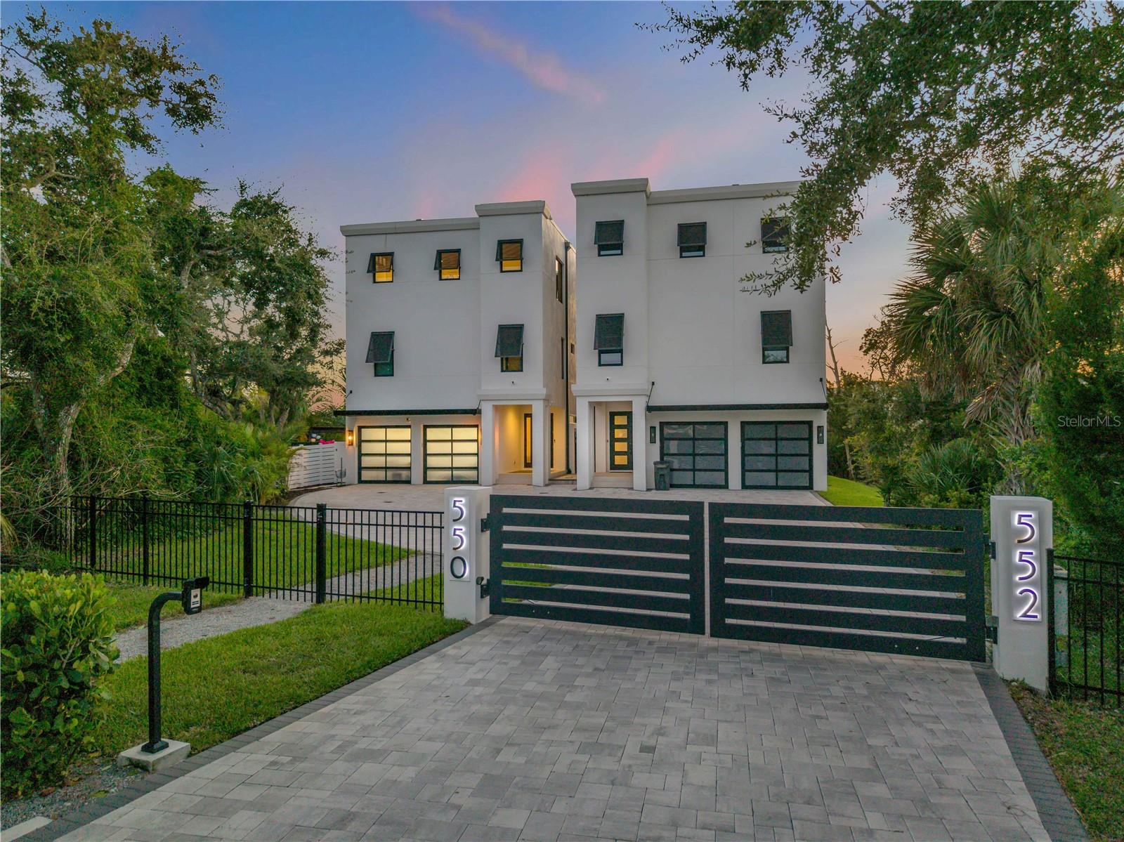 Experience the ultimate in luxury waterfront living with this newly built 2023 modern residence, perfectly situated on Callalisa Creek with direct access to the Intracoastal Waterway. Designed for the avid boater, this exceptional property offers THREE DEEP WATER BOAT SLIPS, A 16,000 LB BOAT LIFT, and effortless access to the open water right from your private dock. Spanning three stories with an elevator, the home showcases sleek architectural design and panoramic views from the third-floor balcony, living room, and modern kitchen. The interior features four spacious bedrooms, each with its own en-suite bathroom, and has been professionally designed with premium finishes throughout, offering both elegance and comfort. Step outside to your private backyard oasis, complete with a brand-new custom pool and spa, expansive wood deck, pergola, and a fully equipped summer kitchen with a pet and kid friendly mosquito, noseeums repellent system that covers 3,000 sqft and controlled by an app on your phone—ideal for entertaining or relaxing after a day on the water. Located in the heart of Central Beach, New Smyrna Beach, this property offers unmatched convenience with golf cart access to the beach, Publix, Flagler Avenue’s shops and restaurants, and Smyrna Dunes Park. This one-of-a-kind estate seamlessly blends modern design, waterfront luxury, and coastal lifestyle—an opportunity not to be missed.