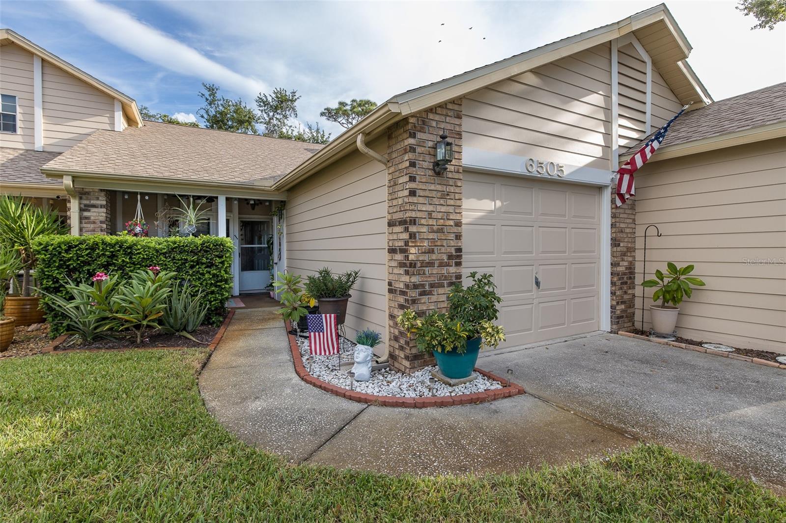 Welcome home to this meticulously maintained 2 bedroom, 2 bath Villa in the sought-after Briar Patch community of New Port Richey. Just minutes from the vibrant downtown area, this 55+ COMMUNITY offers a sparkling community pool, LOW HOA fees, and truly maintenance-free living. From the moment you arrive, you’ll be drawn in by the charming curb appeal, lush landscaping, and private garage. A welcoming front porch sets the tone for morning coffee or evening relaxation. Continue on to the inside and you’ll immediately notice the vaulted ceilings and natural light that make the open floor plan feel bright, airy, and spacious. Beautiful Sky light really enhances the light in this space!!! The kitchen offers abundant cabinetry and a semi-open flow to the dining and living room area, perfect for everyday living and entertaining. The main living areas features newer flooring, fresh interior touches, with sliding doors leading to a versatile Florida room overlooking a peaceful wooded backdrop—with NO REAR neighbors! The spacious and serene primary suite includes an En suite bathroom with oversized vanity, walk-in closet, step-in shower, and access to the Florida room... while the guest bedroom and full bath are thoughtfully placed for privacy and comfort. An indoor laundry area with shelving for storage adds extra convenience. Looking for peace of mind? This home comes with major updates already done for you: NEW ROOF (2025), NEW WINDOWS (2024), EXTERIOR PAINT (2024), NEWER AC (2022), NEWER WATER HEATER (2020), and UPGRADED LIGHT FIXTURES. Purchasing this home FURNISHED IS NEGOTIABLE, making this home completely move-in ready. Whether you’re relaxing in the Florida room, enjoying the community pool, walking the community for fresh air or exploring nearby shops, dining, and entertainment, this home offers the best of Florida’s carefree lifestyle. HOA is LOW $215/MO COVERS Exterior Maintenace, Roof, Pool, Ground Maintenace, Exterior Paint, Trash, Sewer and Shrub trimmings. Short drive to TOP RATED BEACHES, GOLF COURSES, BOATING, MALLS, MEDICAL, SR 54, US HWY 19, AND MUCH MORE! See it, love it, Own it! Let's make this home yours, SCHEDULE YOUR SHOWING TODAY! Your Maintenace free living awaits!