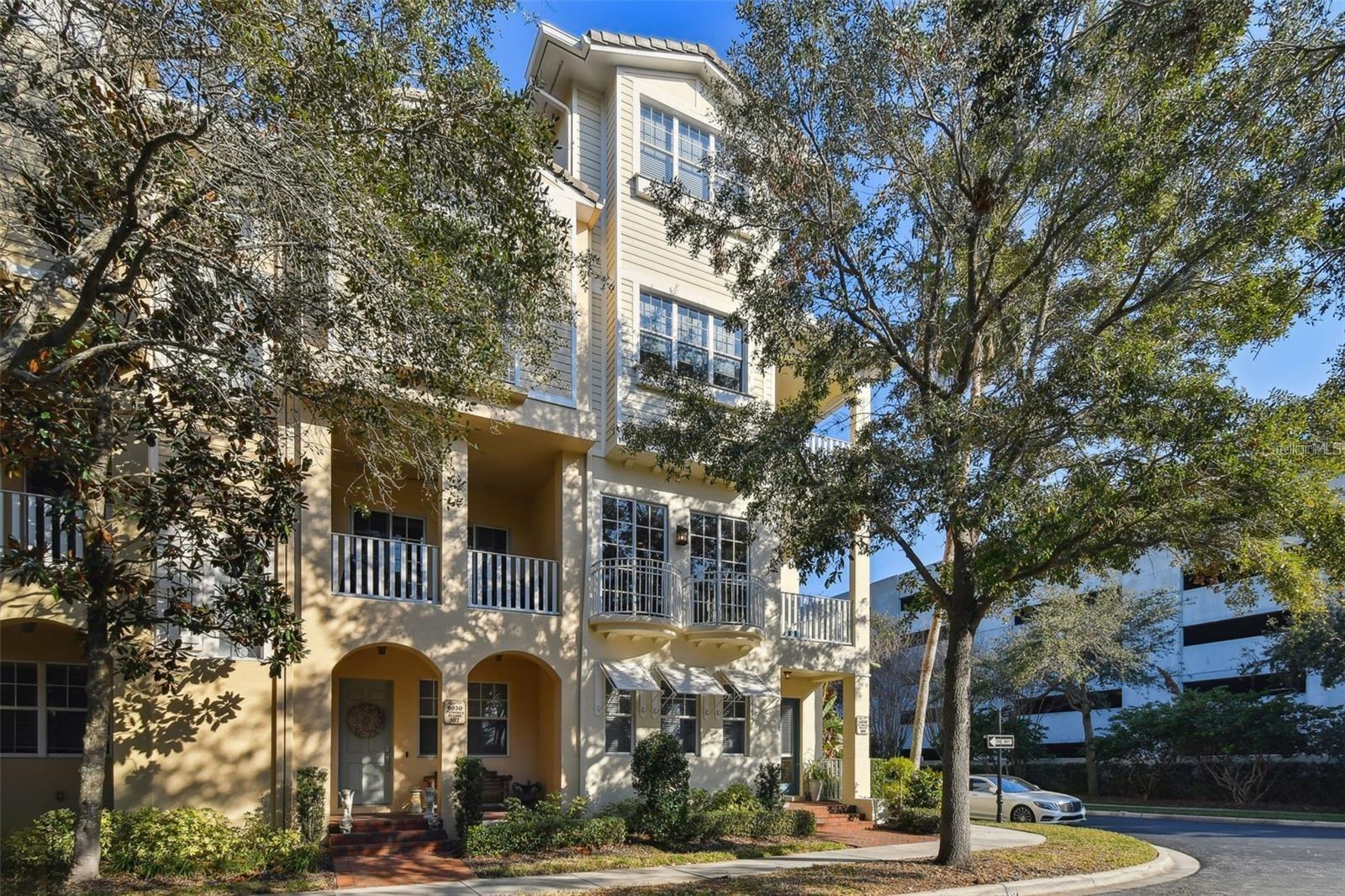 Spectacular 4 Bedroom, 4.5 bath Townhome On The Park! Westshore Yacht Club's highly sought after four story end unit in immaculate condition lovingly maintained by the current owners. Thoughtfully designed floorplan features a PASSENGER ELEVATOR, 10 Ft Ceilings, Crown Moldings, Central Vac System, Hardwood Flooring throughout ( No Carpet! ), Motorized Window Treatments and wonderful architectural details. Welcoming front porch has brick pavers, gracious entry foyer, convenient first floor guest bedroom with en-suite bath and direct access two car garage with plenty of room for storage/shelving. Second level living room is flooded with natural sunlight through floor to ceiling windows, two Juliet plus a large corner balcony, lovely views of the lush tropical landscaped park and a guest's half bath. Beautiful chef's kitchen with granite countertops, raised panel cabinetry, energy efficient stainless steel appliances, breakfast bar, loads of storage and separate windowed dining area. Upstairs primary bedroom includes three sizable closets, tranquil covered balcony, en-suite bath with dual sinks, oval garden soaking bathtub and spa inspired glass enclosed shower. The additional secondary bedroom has a huge walk-in closet, en-suite bathroom and adjacent hall laundry with full sized stackable washer and dryer. Versatile top floor (optional 4th bedroom) features Water Views of Old Tampa Bay, wet bar, another full bath and is ideal for media/game room or an at home office. Dual zoned HVAC units recently replaced plus solid block construction on all four floors with no flooding, damages or loss of utilities during the recent 2024 storms. Westshore Yacht Club is South Tampa's premier 24 hour guard gated waterfront community rich in amenities featuring the exclusive members only Bay Club and Marina, 149 boat slips, two resort style heated swimming pools, outside Tiki Bar, casual poolside or indoor dining, Compass Day Spa, 806 Sunset bar, state of the art fitness center, community and dog park plus exciting resident social functions. Conveniently located with easy access to downtown Tampa and St Petersburg, Westshore business and shopping district, Tampa International and MacDill Air Force Base and Bay Area beaches. RENT INCLUDES CABLE, INTERNET and the ANNUAL BAY CLUB MEMBERSHIP. ANNUAL LEASES ONLY. FULLY FURNISHED OPTION ALSO AVAILABLE, ask about pricing.