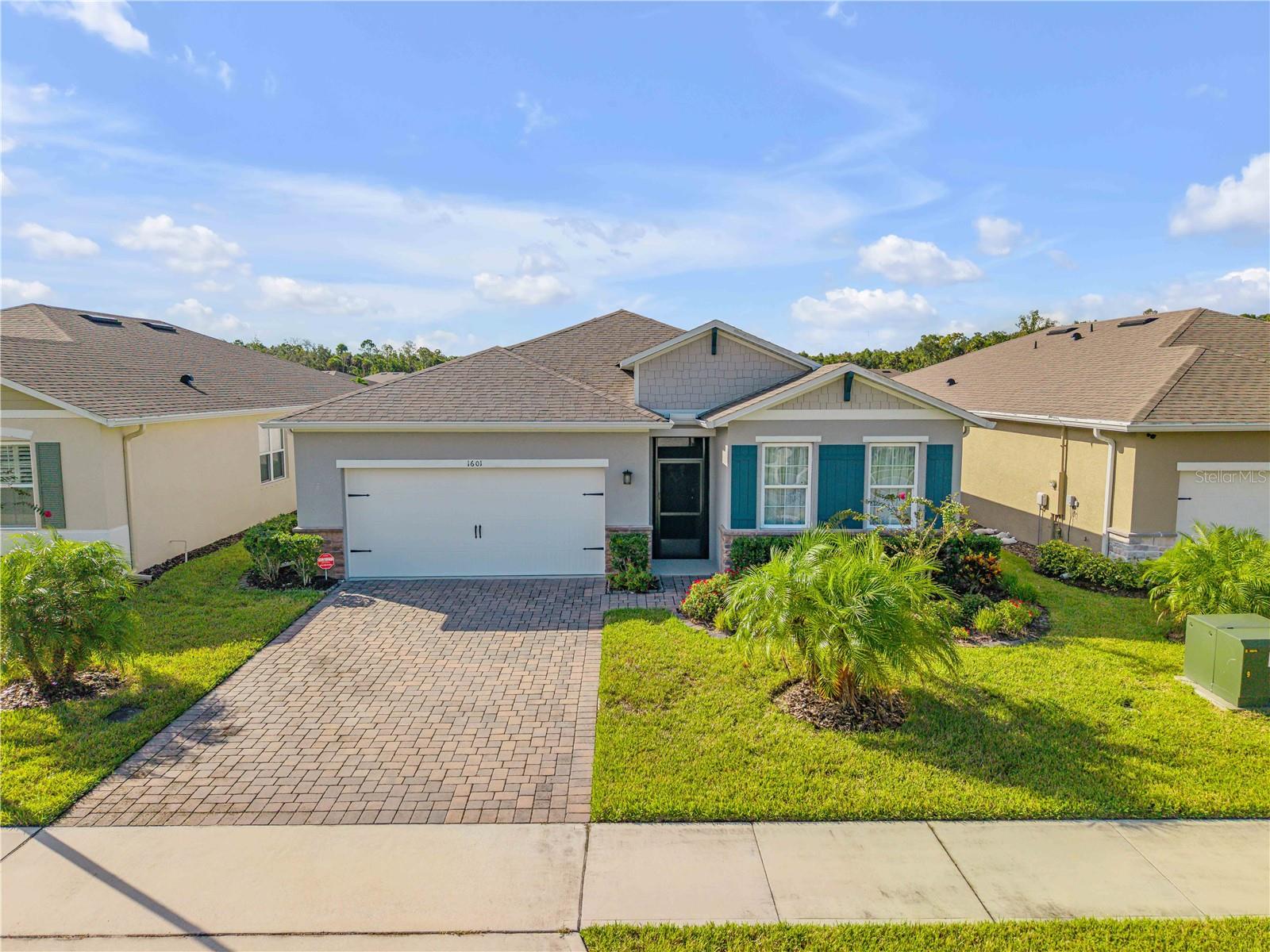 Beautiful lakefront home with stunning water views, all on one level. This solid block residence with stucco exterior offers 9-foot ceilings, plank tile flooring throughout (with carpet in one bedroom), and fresh paint. The open layout captures southern exposure and serene lake views from most rooms. The primary suite features a huge walk-in closet, while the third bedroom includes French doors. Double-pane windows, ceiling fans in every room, and custom lighting enhance comfort and style.
The kitchen is designed for both function and elegance, with 42” white Shaker cabinets topped with crown molding, quartz countertops, a large pantry, and counter seating. Stainless Whirlpool appliances include a 5-burner cooktop with oven, microwave, dishwasher, and side-by-side refrigerator. A double stainless sink with disposal, reverse osmosis water filtration system, and shaker cabinetry in the laundry with utility sink add convenience.
Additional upgrades include smart home technology, comfort-height commodes, knockdown ceilings, keyless entry, stacked stone accents on the exterior, screened front entry, stone border landscaping, full gutters, paver driveway, transferable termite bond, and upgraded palm trees for curb appeal.