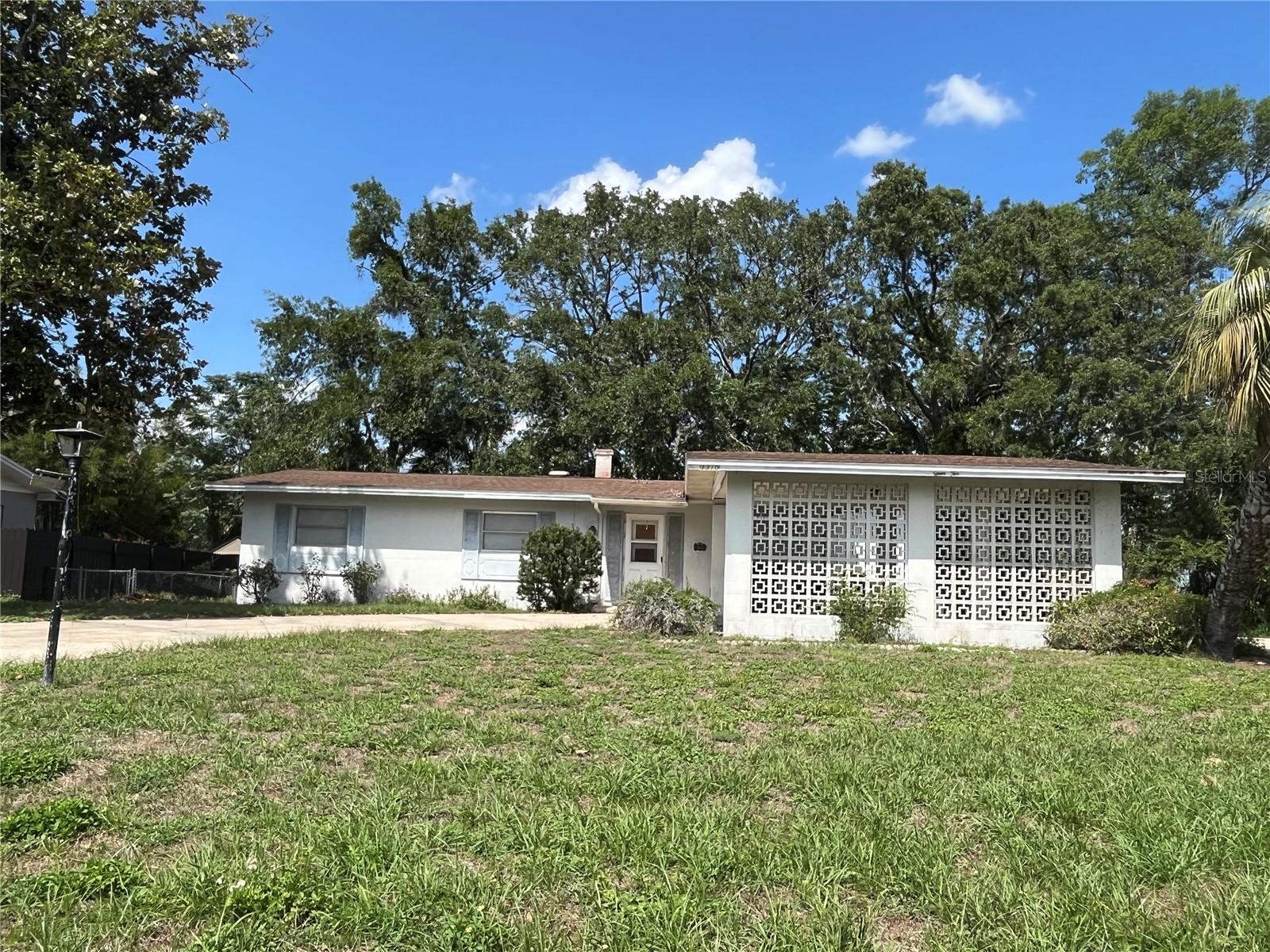 Located in the heart of the WELL-ESTABLISHED NEIGHBORHOOD OF LEESBURG BEVERLY SHORES, this 3-bedroom, 2-bathroom block home sits on a spacious 0.26-acre lot with lovely mature landscaping. Built in 1965, this home boasts over 1,500 sq ft of spacious indoor living as well as a huge covered carport and expansive circular driveway to accommodate all of your house guests. These features, along with NO HOA fees or Deed Restrictions, offer a fantastic opportunity for investors seeking a great rental property or a flip. With just a bit of TLC, this solid block home can quickly become a high-performing rental or a profitable fix-and-flip property. USE YOUR CREATIVITY TO BRING THIS AMAZING DIAMOND IN THE ROUGH BACK TO LIFE!