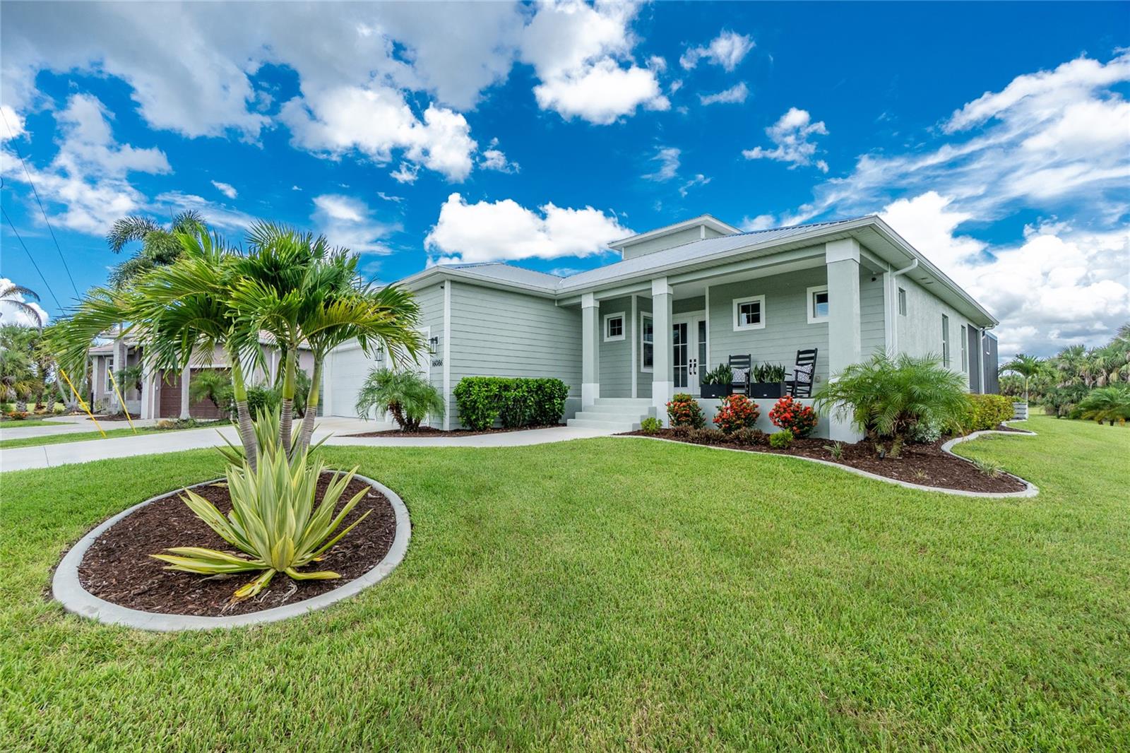Why build, when you can move right into this impeccably upgraded and maintained modern coastal retreat in the highly sought-after community of Burnt Store Lakes. Custom built in 2022 by Southern Style Homes, this elegant residence blends thoughtful design with everyday comfort, all set on a spacious .30-acre lot with serene lake views. From the moment you arrive, the curb appeal shines with a welcoming front porch finished with hardie board style stucco walls, handsome impact resistant double glass entry doors, and manicured landscaping. Inside, the dramatic open floor plan - with disappearing impact glass doors and tray ceiling - is framed by crown molding, plantation shutters, and LVP, while the shiplap accents add character and warmth. At the heart of the home, the magnificent expanded chef’s kitchen is both stylish and functional with abundant white shaker style cabinetry and striking quartz tops. An attractive accent island with farmhouse sink is surrounded with GE Profile appliances including an induction range with pot filler, and an expansive walk-in pantry with solid wood shelving for even more storage. Whether entertaining or enjoying quiet mornings, the flow from the kitchen to the living and dining spaces makes gatherings effortless. An expansive wall of cabinets and counter space, complete with a wine and beverage chiller, make an excellent location for a coffee station or bar. The primary suite is a private sanctuary, offering dual walk-in California closets, spa-inspired bath, and french doors that open directly to the lanai where peaceful greenbelt and lake views greet you each morning. Guest rooms are equally well-appointed with custom closets and access to two full baths, including one with a glass-enclosed walk-in shower—perfect for family or visiting friends. Step outside to your own resort-style escape. A picture-window pool cage frames the sparkling 24x12 saltwater sports pool with PebbleTec finish, sun shelf, spa ledge, and a paver pool deck. Entertaining is elevated with a full summer kitchen—stone counters, grill, sink, and beverage fridge—making weekends feel like vacation. Additional highlights include a 3-car garage with storage system, pre-wiring for a whole-home generator, and irrigation with the capability to convert to a lake-pump for efficient lawn care. Every detail—from impact windows and doors to landscape drip lines and custom landscape lighting—was thoughtfully selected for style and ease of living. Located in Burnt Store Lakes, you’ll enjoy a quiet neighborhood atmosphere with access to walking paths, a community park, and kayak launch, while being just minutes from Burnt Store Marina’s golf, dining, and boating. Shopping and dining can be found in either direction - north to Punta Gorda or south to Cape Coral and Fort Myers.