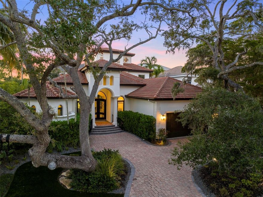 Discover the pinnacle of waterfront living within Sarasota’s coveted Oyster Bay Landings, a haven for boating enthusiasts. Nestled in an exclusive gated community, this bespoke residence epitomizes luxury, boasting unparalleled architectural finesse and craftsmanship. Pass through the grand custom-made iron double doors to unveil an inviting open floor plan with beautiful travertine flooring. The heart of this home lies in its chef’s kitchen, a culinary masterpiece boasting top-tier Thermador and Sub Zero appliances alongside an expansive granite-topped island, ideal for entertaining. The home features a formal dining space as well as a casual breakfast nook adjoining the kitchen. Retreat to the tranquility of the first-floor primary suite, showcasing two generously-sized closets with custom wood finishes and a recently remodeled en suite bathroom. Offering four bedrooms, five bathrooms, and flexible bonus spaces, this residence is replete with storage and living options. Outdoors, revel in the private oasis of the courtyard-style pool area, complete with a recently refurbished heated pool, outdoor kitchen, and a convenient outdoor shower. You’ll enjoy additional luxuries including a climate-controlled 2,000-bottle cedar planked wine cellar and a home theater perfect for cozy movie nights. This home is equipped with exceptional features such as an emergency generator, whole-house water filtration system, dual laundry facilities, a cast stone gas fireplace, energy-efficient elements, and indoor air quality enhancements. Enjoy the convenience of a garage workshop and bid farewell to mosquito worries with the installed “Mosquitonix” misting system. Within steps lies your 15,000 lb boat lift, providing easy access to Sarasota Bay without bridges. This exquisite residence embodies a true masterpiece, offering a rare chance to reside within the exclusive enclave of Oyster Bay Landings, moments away from Sarasota's vibrant city center and the pristine shores of Siesta Key Beach. Don’t miss this unparalleled opportunity.