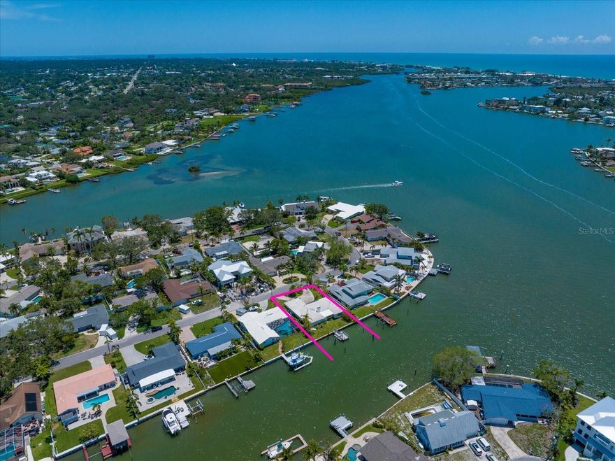 With a graceful nod to Mediterranean style, this waterfront Harbor Hills home offers a rare
opportunity to renovate or rebuild on a stunning piece of property. Hurricane flood damage has
impacted the home, and it is being sold as is, providing a blank canvas for your vision. Set
behind a circular driveway, the home welcomes you with double entry doors and a traditional
floor plan. Inside, a spacious sunken living room with a cozy fireplace flows seamlessly to a
light-filled family room where walls of windows frame tranquil water views. The large formal
dining room features floor-to-ceiling glass, perfect for soaking in mesmerizing sunsets, and sits
adjacent to the kitchen, making entertaining effortless. A split-bedroom layout ensures privacy,
with the oversized primary suite offering bay windows, a walk-in closet, water views, and a
generous ensuite complete with a sunken garden tub and walk-in shower. An additional
bedroom is bathed in natural light and ideal for guests or a home office. Outside, enjoy the
perks of a boater’s paradise with a private dock with deep water berth, offering quick and easy access to the
Intracoastal Waterway and open Gulf waters beyond. Located near shopping, local restaurants,
and world-class beaches, this is an extraordinary chance to bring new life to a home in a
desirable waterfront location. Don’t miss this great opportunity!