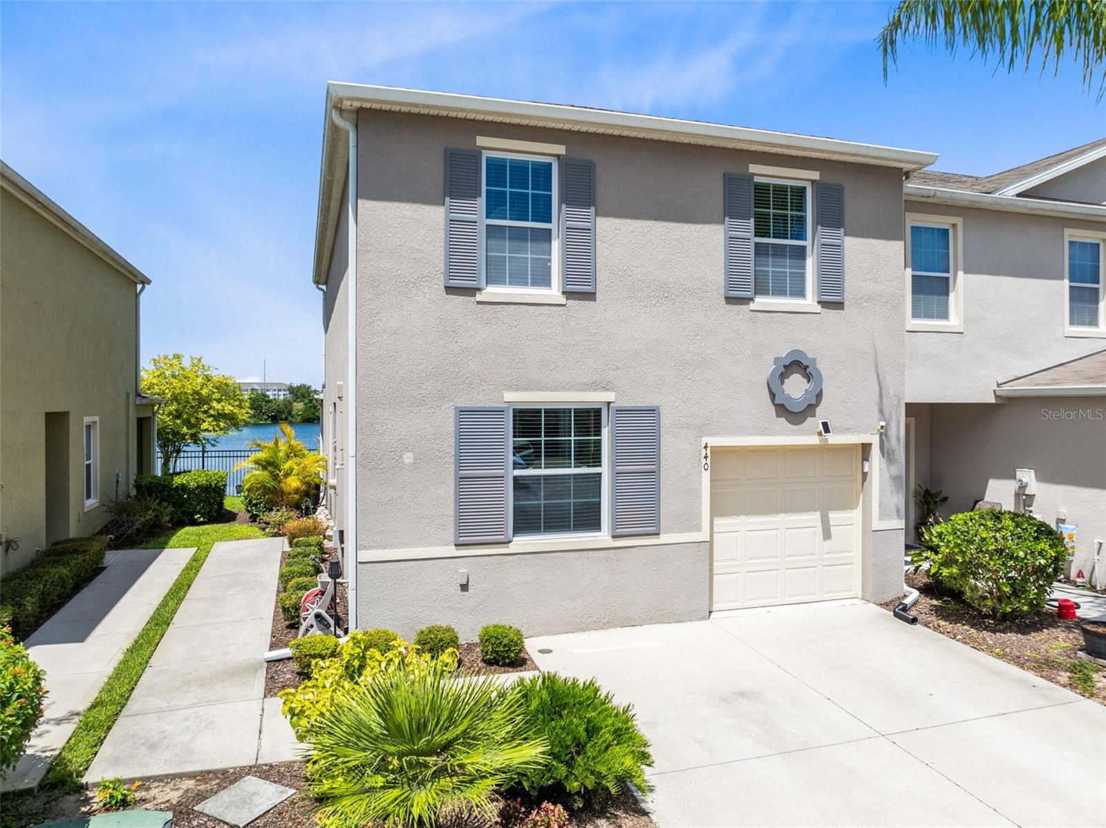 WELCOME HOME to this resort style, sunny END-UNIT townhome that OVERLOOKS A TRANQUIL WATER VIEW of Lake Bluff from your very own, PRIVATE SCREENED-IN PATIO. As you walk up your PRIVATE SIDEWALK with individual entry, step inside to this freshly painted spacious residence that offers over 1,700 sq ft of open living space with a bright and airy layout. The kitchen features quartz countertops and a breakfast bar, flowing seamlessly into the living and dining areas with ample space for lounging and entertaining guests. Also, downstairs is a conveniently located powder bath. As you make it upstairs, there is a loft space separating the bedrooms, perfect for an office or extra hangout area. The primary suite features a WALK-IN CLOSET and private bath complete with dual sinks. The two additional bedrooms upstairs share their own dedicated full bathroom. Enjoy maintenance-free living with a LOW HOA which includes a resort-style community pool and exterior lawn maintenance. Convenient access to Reunion, Champions Gate, 1-4, short drive to Disney and so many wonderful area attractions, dining, major highways, and shopping are all at your fingertips! Don't miss your chance to live in this peaceful, centrally located community.