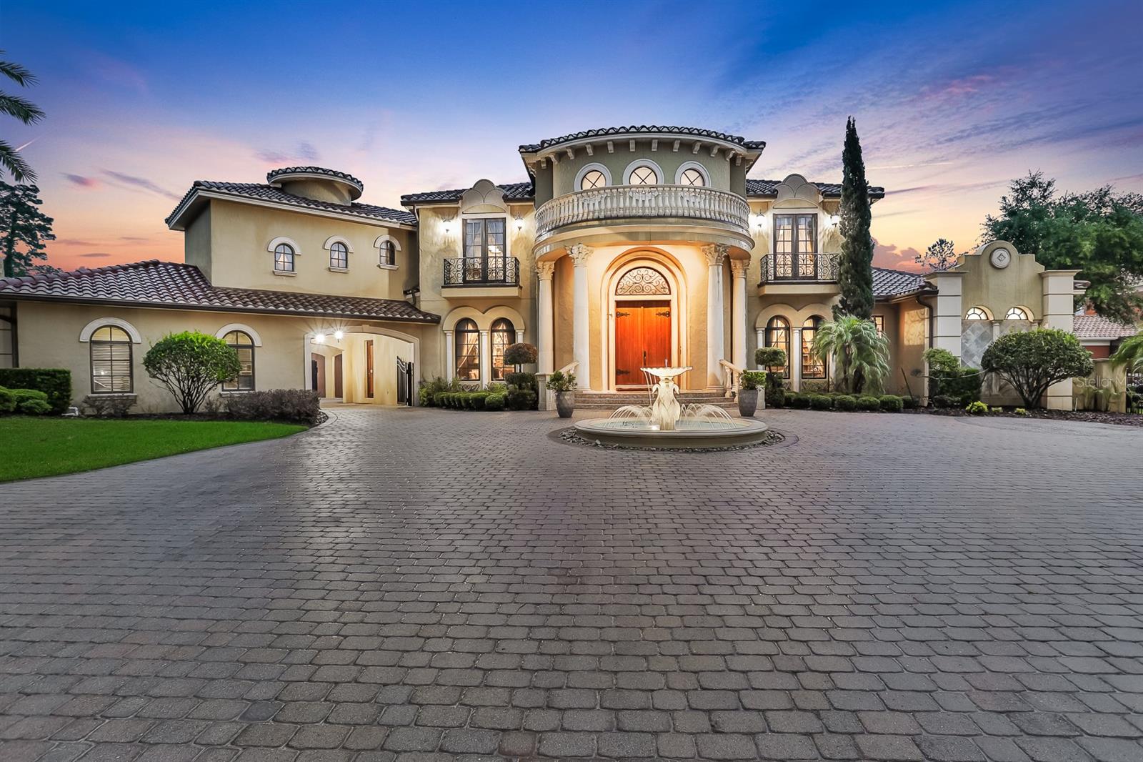 One-of-a-kind Charles Clayton masterpiece perfectly positioned on a 1-acre golf-front homesite in Seminole County's premier 24-hour guard-gated neighborhood of Alaqua. Highlighting the very best of time-honored architecture and old-world craftsmanship, no detail has been overlooked nor expense spared in the construction of this palatial estate spanning nearly 9,000 square feet. Arrive via a fully brick-paver drive to incredible 12' tall solid wood double front doors and immediately be amazed by a nearly 30' high ceiling and dual circular stairways in the grand entry. Featuring 6+ bedrooms, 9 bathrooms(5 full, 4 half), office/library, wine cellar, theater room, billiard room, bonus room, guest house, outdoor kitchen/bar, and much, much more. Exquisite molding, ceiling treatment, and flooring are everywhere you look; one discovers more with each glance. The chef's kitchen is ready for home cooks and professionals alike with Viking Professional range, 2 SubZero built-in refrigerators, Miele coffee station, warming drawer, and copious storage - all with hand-made custom cabinetry and solid wood fascia. The master bedroom on the main level is a destination truly unto itself with oversized sitting area, spa-quality master bath, and massive dual walk-in closets. Entertaining friends and family alike present seemingly limitless options - enjoy a movie in the theater room, host friends for a dinner party in the game room with built-in custom bar, or relax on the covered lanai amidst a resort-style backyard with sparkling oversized pool and outdoor kitchen, bar, and fireplace! A detached guest house is ideal for guests staying for an extended period of time and has the flexibility to handle whatever you can dream up. The home office/library features exquisite custom built-in cabinetry and its own walk-in closet offering incredible storage should the need arise. A saltwater aquarium splits the family room from the eat-in space in the kitchen, while the home gym features a sauna; perfect for post-workout! From an elevator helping with access to the second level, to a generator ensuring no power interruptions, everything has been thought of and obsessed over. Truly too much to list; all with the conveniences of world-class golf, shopping, restaurants, schools, business parks, and highways nearby. This property may be under audio/visual surveillance.