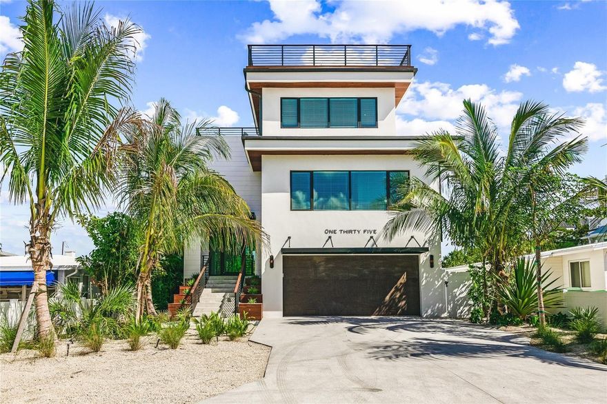 Welcome to your dream home on Lido Key! This impressive 3-story residence offers a luxurious living experience with breathtaking water views from its private rooftop oasis. With 6 bedrooms, 6 full bathrooms, and 2 half-bathrooms spread across 3,914 square feet, this home is a masterpiece of modern design, boasting sleek clean lines, abundant natural light, and high-end finishes throughout. As you step into the grand entrance on the main floor, you'll be captivated by the open-concept layout and the panoramic wall-to-wall windows that showcase the stunning living, dining, and gourmet kitchen areas. The kitchen is a chef's delight, featuring stylish pendant lighting, gold accents, a massive island with a waterfall quartz countertop, and herringbone wood tile flooring. Top-of-the-line stainless steel appliances, double ovens, and elegant fixtures complete the sleek design. This home offers multiple dining options, perfect for entertaining. The open-concept dining area is ideal for indoor dining, while the adjacent lanai provides an al fresco experience where you can savor the warm sea breezes. For a more intimate setting, descend the stairs to your own tropical oasis. Surrounded by lush palm trees and greenery, this tranquil retreat features a sparkling heated pool and spa, creating a private resort-like experience. With 6 bedrooms and 6.5 bathrooms, this home provides ample space for your family and guests, each room more luxurious than the last, with unique features adding to the overall opulence. The master retreat, located between the 1st and 2nd levels, offers a serene escape. Relax in the deep soaker stand-alone bathtub while enjoying fantastic views, or pamper yourself in the en-suite bathroom with his and her custom-built vanity sinks, a large walk-in shower with designer tile and fixtures, a water closet, and a walk-in closet. This home also offers the rare convenience of a commercial elevator, allowing easy access to the next level, where you'll find four additional bedrooms, each with its own en-suite bathroom featuring porcelain tile in the bathrooms and wood tile flooring in the bedrooms. Gold accents and custom built-ins add to the beauty found throughout this floor. A full-sized laundry room with two stacked washers and dryers ensures convenience and efficiency. Ascend another flight of stairs, and you'll discover an additional bedroom, attached en-suite bathroom, and a half bath that lead to the spectacular rooftop deck. Enjoy stunning views of the Gulf, dine on the covered deck year-round, and relish in the Florida sunshine from multiple seating areas. Whether you're sunbathing, entertaining guests, playing a game of corn hole, or witnessing awe-inspiring sunsets, the possibilities are endless in this magical space. Located in the heart of desirable Lido Key, just steps away from one of Florida's most beautiful beaches and the renowned St. Armands Circle, this home offers easy access to fabulous dining and shopping. What's more, this neighborhood has no CDD fees or HOA restrictions, providing you with the freedom to truly enjoy the luxury of coastal living.Don't miss the opportunity to turn your dream into a reality. Embrace the true meaning of luxury living in this stunning Lido Key home.