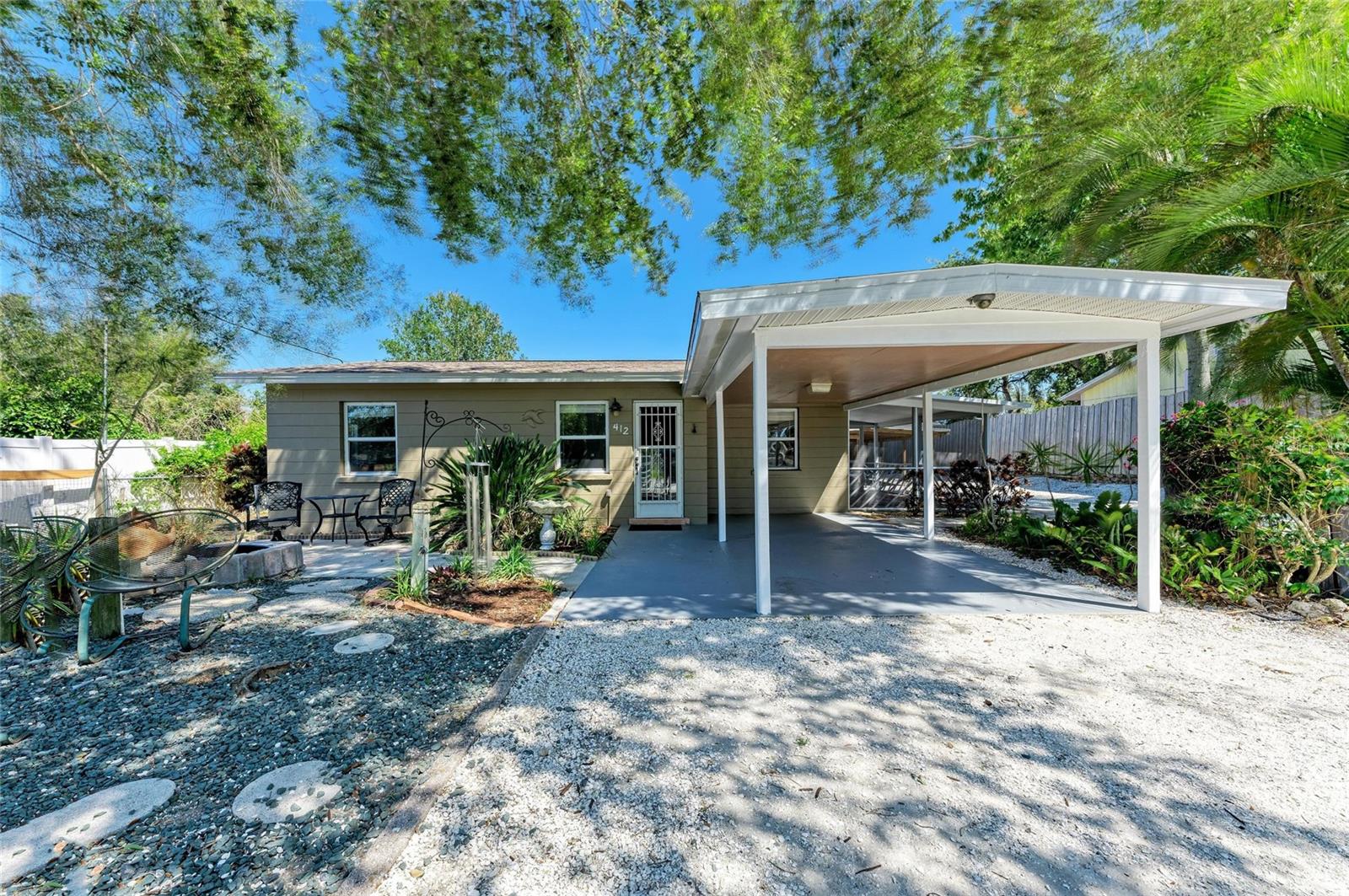 Nestled between Roberts Bay and Dona Bay, this charming home offers a prime location just minutes from the stunning Gulf beaches, the Legacy Bike and Walking Trail, shopping, and dining. Top-rated schools and a new state-of-the-art hospital are also conveniently nearby. At the end of the street, a county boat ramp provides easy access for boat and kayak launching directly into the Gulf. Best of all, this home is not in a flood zone and has remained high and dry through multiple storms and hurricanes over the years. Located in Nokomis, this well-maintained 2-bedroom, 1-bath concrete block home is connected to city water and has been cared for by the same owners for nearly 30 years. Recently painted inside and out, it features a newer roof (just 2 years old and still under warranty), providing peace of mind for years to come. With approximately 720 sq. ft. of living space under air, the home also includes an attached 120 sq. ft. screened porch for added comfort. Inside, an open-concept kitchen, living, and dining area creates a spacious feel, while a dedicated laundry space adds convenience. Decorative tile flooring extends throughout the main living areas, while both bedrooms feature wood laminate flooring and ample closet space. The full bathroom boasts a tiled tub/shower combination, vanity, and tile flooring.  Additional features include ceiling fans throughout and 2-inch white faux wood blinds with coordinating valances. French doors leading from the dining area to the screened-in porch with beautiful terra cotta Saltillo tile—perfect for relaxing or entertaining. The fully fenced and gated yard offers a secure space for pets, and outdoor shower and easy-to-maintain tropical landscaping to enhance the tranquil setting. Enjoy the lush surroundings, which include banana trees, bird of paradise, areca palms, a jasmine-covered pergola, and two ornamental fish ponds. Several concrete and paver walkways lead to patios, ideal for barbecues and gatherings. For added convenience, the home provides ample parking, including a carport and additional covered and open space for a boat, motorhome, or extra vehicles. Don’t miss this opportunity to own a well-kept home in a prime location with no flood worries and plenty of outdoor space to enjoy Florida living at its best!