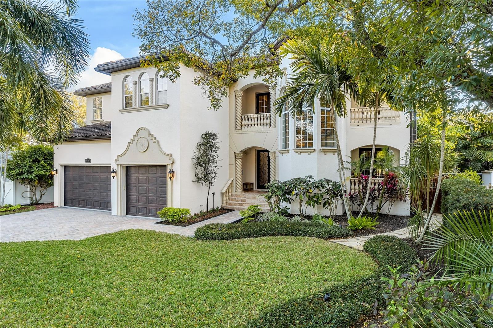 One or more photo(s) has been virtually staged. Your Mediterranean Island Oasis awaits! Situated on one of Davis Islands’ most desired streets, this 5 bedroom, 5 full and 1 half bath pool home offers 4,791 square feet of heated living space, plus a 3-car garage, covered balconies, patios, and a fully screened pool with spa! Welcomed through double doors, you will feel as if you are immediately transported to a luxurious resort style paradise upon walking into the 2-story formal living space with gas fireplace and floor to ceiling windows showcasing the tropical sanctuary beyond. The great room is indeed the heart of the home, with an open concept space for living, dining and a well-appointed kitchen with 6 burner gas stove, dual built-in ovens, walk-in pantry, center island with prep sink, and breakfast bar. Pocket sliding patio doors open to the expansive covered patio and pool area creating the perfect opportunity for embracing indoor-outdoor living and truly enjoying the Florida Lifestyle! Fitting for an in-law suite or entertainment room, the 5th bedroom and full bathroom features a private outdoor entrance directly off the covered patio. An additional flex space and powder bath round out the first floor. Make your way up the grand staircase to the 2nd floor mezzanine presenting views of the formal living area below and an ideal split bedroom floor plan. The left wing features the primary suite including dual walk-in closets with built-in shelving systems, a spacious private balcony and expansive en-suite bathroom with dual vanities, large soaking tub and oversized walk-in shower. Two additional bedrooms, each with private en-suite baths close out this side of the home. On the right wing, an oversized bedroom with private balcony and full en-suite bathroom is ideal for both family and guests alike! The laundry room with ample cabinets and counter space completes the 2nd floor. The crown jewel of this home is the fully screened resort style pool with sun shelf, highlighted by bubbling fountains and spa surrounded by lush tropical landscaping and patios, offering a staycation location anytime you are ready! The convenient and low maintenance turfed and fully fenced side yard is perfect for your furry friends! Just 5 minutes to Downtown Tampa, enjoy the best of slow-paced “island life” with superior access to Tampa’s vibrant Downtown & Water Street. Davis Islands is home to a private airport, yacht club, parks, beaches & dog beaches, including a charming village with local shops and restaurants. The Island is unmatched in the appeal for luxury living. Bring your golf cart, boat, plane and get ready to live your Florida dream on beautiful Davis Islands. Bedroom Closet Type: Walk-in Closet (Primary Bedroom).