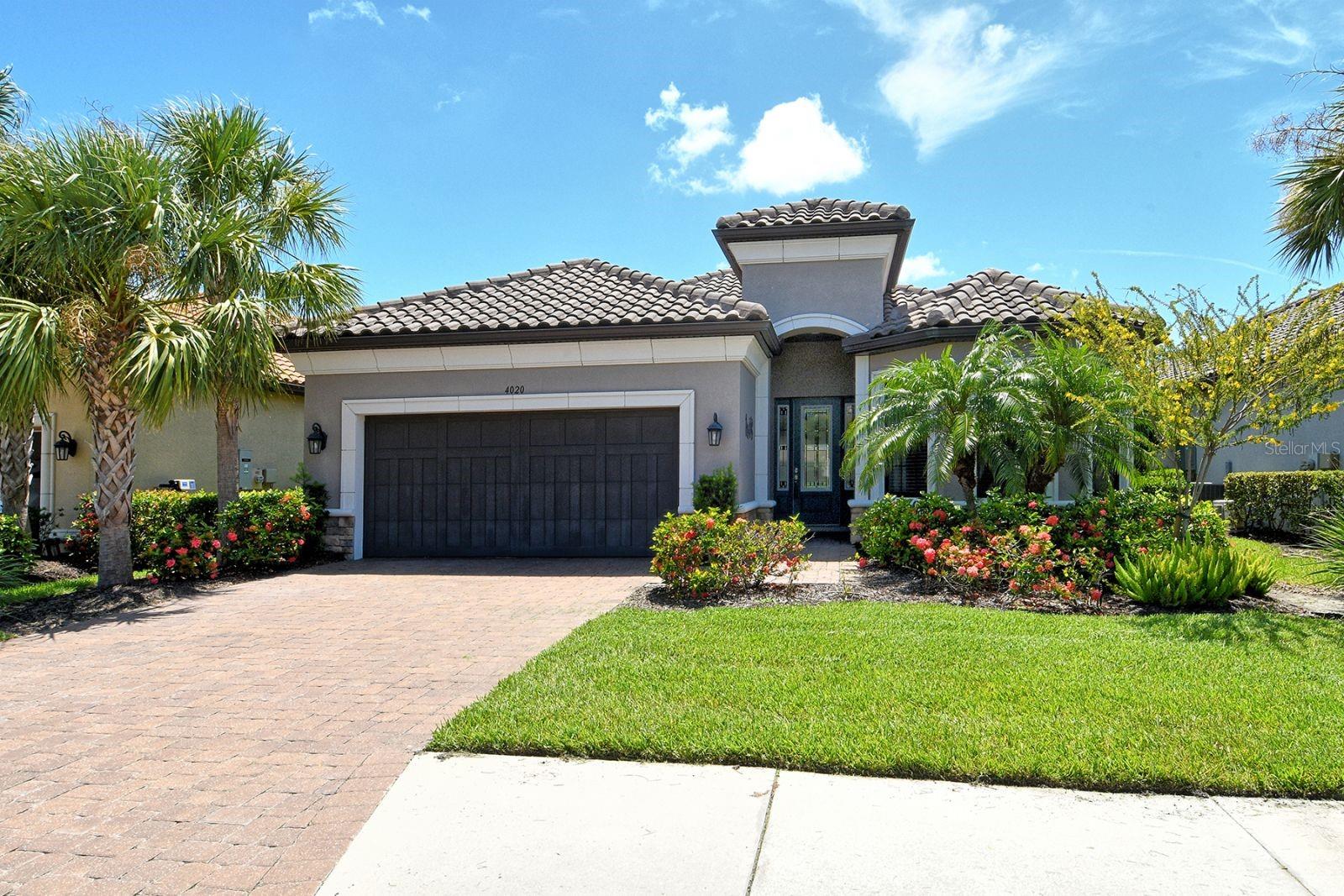 This stunning 3-bedroom, 3-bath home with den offers an exceptional blend of luxury and comfort in the highly sought-after Cobblestone at Palmer Ranch community. The Taylor Morrison Lazio floorplan is designed with spacious, open-concept living areas filled with natural light, and split bedrooms with en suite baths for privacy. The upgraded kitchen is a chef’s dream, featuring a gas cooktop, built-in appliances, closet pantry, and quartz counters for effortless cooking and entertaining. The seamless transition to the expanded lanai provides the perfect outdoor living area including a sparkling heated pool with waterfall feature overlooking the tranquil lake. With plenty of seating areas for relaxing, and a summer kitchen, this area will be a favorite for the whole family. Inside, tray ceilings, crown molding, and elegant lighting add an air of sophistication, while the home’s excellent design ensures that every room is both functional and inviting. As a resident of Cobblestone at Palmer Ranch, you’ll have access to amenities including a clubhouse, heated pool & spa, tennis/pickleball courts, and fitness center. Access to the Legacy Trail is just a few minute bike ride from home. Plus, you’re just a short drive from gorgeous Gulf beaches, challenging golf courses, as well as Downtown Sarasota, Siesta Key, and a variety of delightful restaurants, shops, arts and cultural events, and a myriad of recreational opportunities. This Sarasota home offers the perfect blend of tranquility, convenience, and luxury in an idyllic setting.