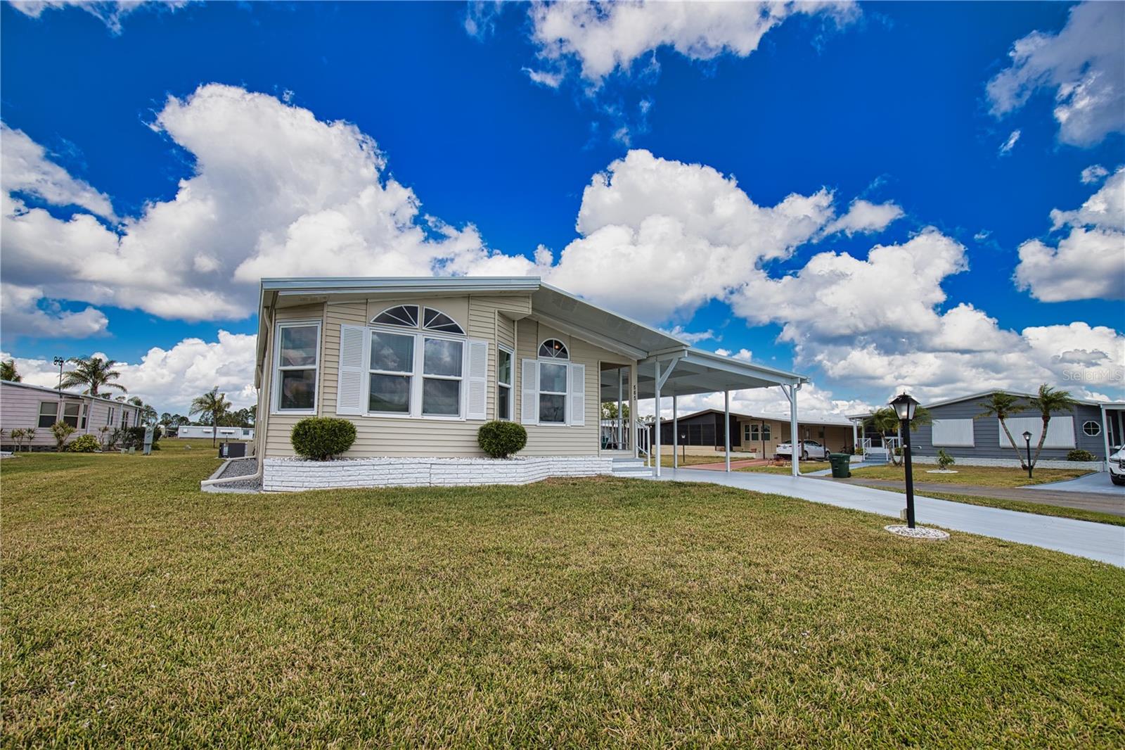 Discover the essence of Florida living in this captivating home! Tucked away on a serene street in a vibrant 55+ community, this is your golden opportunity to embrace the Florida dream. As you step inside, you'll be welcomed by a spacious living and dining room combination, bathed in natural light thanks to an abundance of windows that create a warm and inviting atmosphere. Flowing seamlessly from the dining room, the sizable kitchen beckons you to create culinary delights, while the charming breakfast nook—complete with a built-in desk—provides an ideal space for your home office needs. Retreat to the generous primary bedroom, featuring double closets and a beautiful ensuite bathroom with double sinks, plenty of cabinets, and a luxurious walk-in shower, ensuring your comfort and relaxation. Your guests will feel right at home in the cozy second bedroom, conveniently located near an additional bathroom just down the hall. For added convenience, a dedicated laundry room enhances everyday living, leading you to a delightful bonus room. This sunlit space, surrounded by windows, is perfect for entertaining friends and family or unwinding with your favorite show. Recent updates amplify this home’s appeal, featuring a brand-new shingle roof (2024), a modern A/C unit (2023), sparkling new windows (2023), and a freshly constructed lanai,
shed, and carport (2023). Don’t miss your chance to call this enchanting property your own. Golf Cart available for a separate purchase. The Community of La Casa, where 974 stunning homes are elegantly nestled among a tapestry of native trees, offering a serene escape surrounded by spacious common areas and eight picturesque lakes. Our generous lots average an impressive 60 by 80 feet, providing ample space for your dream home. Perfectly situated between Sarasota and Fort Myers, La Casa embodies the ultimate lifestyle on Florida’s Gulf Coast—a true boaters paradise with direct access to the breathtaking Gulf of Mexico. Enjoy the convenience of nearby shopping, exciting sightseeing, world-class golfing, and abundant fishing and boating opportunities, all while indulging in the rich culture and refined elegance that Southwest Florida is celebrated for. As you immerse yourself in the warmth of Southwest Florida’s winters, you’ll find yourself in a relaxed and unhurried atmosphere, far removed from the hustle and bustle of the east coast. Our community is adorned with lush, mature landscaping that reflects the loving care both residents and management dedicate to preserving its beauty. At La Casa, you’ll discover some of the finest pools in the area. Our crowning jewel is a magnificent 40 by 60-foot swimming pool, maintained at a perfectly inviting 87 degrees. Just a short stroll away, you’ll find our cozy 20 by 40-foot pool, nestled charmingly between the clubhouse and the Activity Building. Both pools feature adjacent hot tubs, ideal for unwinding after a refreshing day of golf or an invigorating game of tennis. Stay connected while basking in the sun with our complimentary wireless Internet (Wi-Fi), available at the Clubhouse, Activity Building, and Recreation Hall. Whether you’re catching some rays or catching up on emails, La Casa has it all. Does this sound appealing? La Casa is not just a community; it’s a welcoming family-friendly haven.