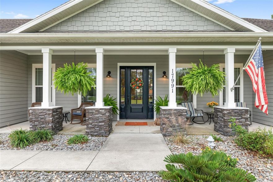 Discover this beautifully crafted 4-bedroom, 3.5-bath custom home offering 3,117 sq. ft. of living space on 1.06 acres in the highly desirable Meadow Glen community of Alachua. Thoughtfully designed with a split floor plan, the home showcases 11’ ceilings, elegant architectural details, and a seamless blend of comfort and style.  Step through the front door into a spacious foyer with a private home office and convenient half bath. The light-filled great room has a vaulted ceiling, shiplap accent wall and graceful pillared archways that flow into the dining area and kitchen. Culinary enthusiasts will appreciate the professional-grade stainless steel appliances, including two convection ovens, a gas cooktop, smart refrigerator, under-cabinet lighting, granite counters, and an impressive 11-foot island perfect for seating and entertaining.  The owner’s suite overlooks the backyard and features a spa-like bathroom with a large walk-in shower, jetted soaking tub and an expansive 10x10 custom closet. Three additional bedrooms are located on the opposite side of the home, each offering generous closet space. A private guest suite includes its own bath and direct access to the covered patio.  Enjoy outdoor living with a fully equipped summer kitchen featuring a built-in KitchenAid grill and 36” Wolf gas range. The fenced backyard offers ample room for a pool, garden, or play area, enhanced by mature lemon, lime, and apple trees.  Additional features include a large laundry room with built-ins and folding station, walk-in pantry, mudroom, site-built storage shed and an oversized 28x28 garage with roughed-in plumbing. Recent updates include new bedroom carpeting and fresh interior paint (2025). Energy-efficient with Clay Electric, two Rinnai tankless water heaters, Carrier HVAC system, and Delta fixtures.  Enjoy peaceful country living with quick access to Gainesville, UF, Publix, dining, shopping, and I-75. This home is truly move-in ready.