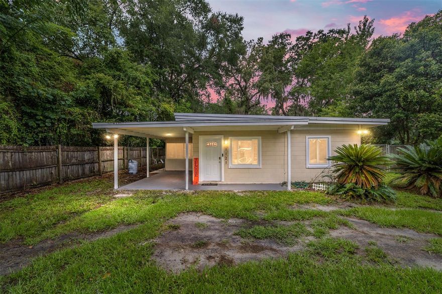 The interior of this 2 bedroom 1 bath home has been fully renovated and now features new metal roof replaced in 2020, new  windows, doors, tile, and plumbing. The kitchen has been upgraded with brand new cabinets, stainless steel appliances, a large stainless apron sink, and a spacious granite counter top/bar. Other upgrades include a new instant hot water heater, AC, travertine-tiled shower with mosaic tile accents, light fixtures/fans, baseboard, crown, and trim. Home is an operating AIRBNB and would a perfect TURNKEY investment property or primary residence as the furniture will convey with sale. The interior and exterior have been freshly painted,  This home is in a prime location, just steps away from the new Lucky's Supermarket, restaurants and 4 min drive to UF.
