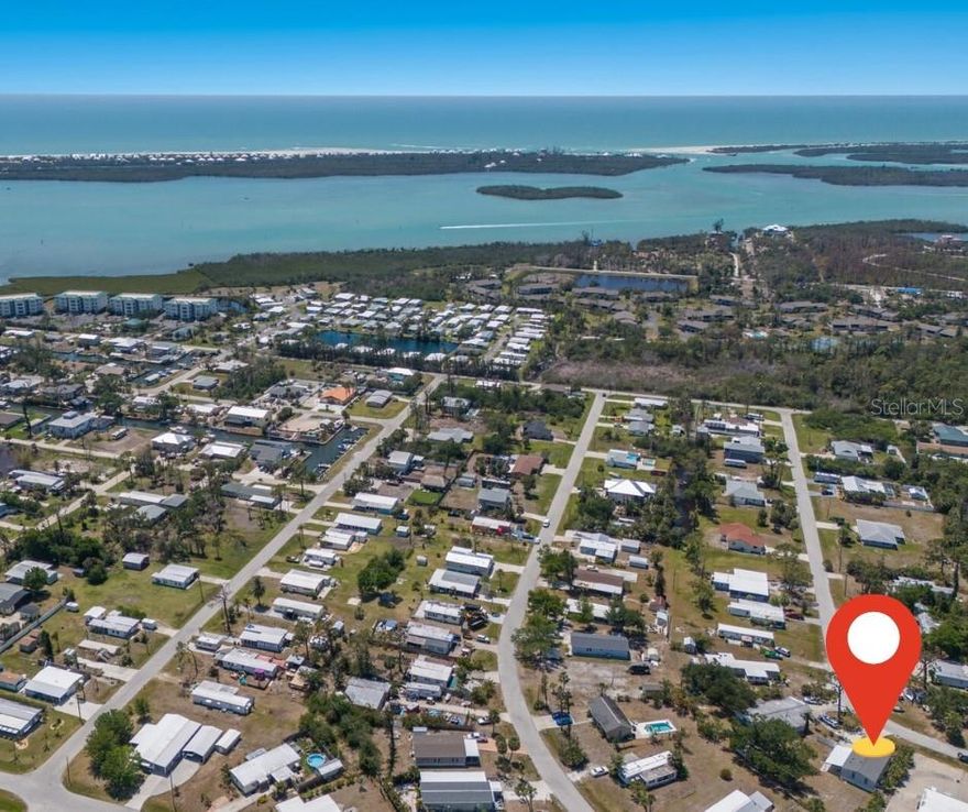 TURNKEY FURNISHED. NO HOA. NO LOT LEASE. NO AGE RESTRICTIONS. YOU OWN THE LAND! Welcome home, where elevated coastal living meets exceptional value in the heart of Grove City. This immaculate 2-bed, 2-bath home sits on an oversized lot in a quiet, non-deed-restricted neighborhood with public water/sewer—and no flooding. Feel the fresh ocean breeze as you arrive, then step inside to vaulted ceilings, traditional sheetrock walls (no vinyl paneling or seams), ceiling-mounted air vents, and vinyl plank flooring throughout. The open layout lives more like a site-built home than a manufactured one. You'll love the butcher block countertops, soft-close shaker cabinets, and bright, airy design. Sip morning coffee in the sunrise-filled primary bedroom and wind down in the evening from the enclosed sunroom, perfectly positioned to take in stunning southwest-facing sunset views. The tropical landscaping features plumeria trees, a triple pygmy date palm, pitch apple hedges, and lush Areca palms for privacy. Relax around the fire pit under the mature oak tree and soak up the Florida lifestyle year-round. Nearly every inch of this home has been improved in the past 3 years, the home features a new roof with hurricane clips, fully remodeled kitchen and baths, new stainless steel appliances, new vinyl plank flooring throughout, new interior paint, new ceiling fans, a whole-house re-pipe with PEX plumbing, a new carport, all new electric panel with whole-house surge protection. The home is elevated and permanently attached with hurricane straps for added peace of mind, and has had no hurricane damage from the 2023 and 2024 storms. Love boating, fishing, or kayaking? This location is a dream. Just 1 mile away, Stump Pass Marina offers boat slips and full-service amenities. You're also steps from a nearby canal where slips may be available to rent or purchase, offering quick access to the Intracoastal and open Gulf waters—with no bridges. Other nearby marinas include Cape Haze Marina, Skip’s Marina, Quality Boats, and Gasparilla Marina, all just minutes away. Paddle through scenic flats, cast your line in world-class waters, or cruise to waterfront restaurants and sandbars with ease. Golfers will love being surrounded by multiple premier golf courses within a 1–2 mile radius, including Oyster Creek Golf Club, Myakka Pines, and Riverwood Golf Club, offering year-round recreation just around the corner. Craving sun and sand? You're only 3 miles from the pristine beaches of Manasota Key, and a short drive to the coastal beauty of Boca Grande—some of the most stunning, lesser-known beaches on Florida’s Gulf Coast. Looking for shopping, dining, and entertainment? You’re just a short 13 miles from Costco and the vibrant energy of Wellen Park, home to charming shops, great restaurants, live music events, and family-friendly fun. Catch a spring training game or concert at CoolToday Park, the Atlanta Braves’ state-of-the-art stadium. Farmers markets, waterfront bars, local boutiques, and grocery stores are all easily accessible, making this one of the most well-connected yet laid-back locations on the Suncoast. Whether full-time, snowbird, or investor, this is a rare opportunity to own a pristine, elevated home with land in one of the Suncoast’s most desirable and well-connected areas. Schedule your showing and start living the Florida lifestyle you’ve been dreaming of!