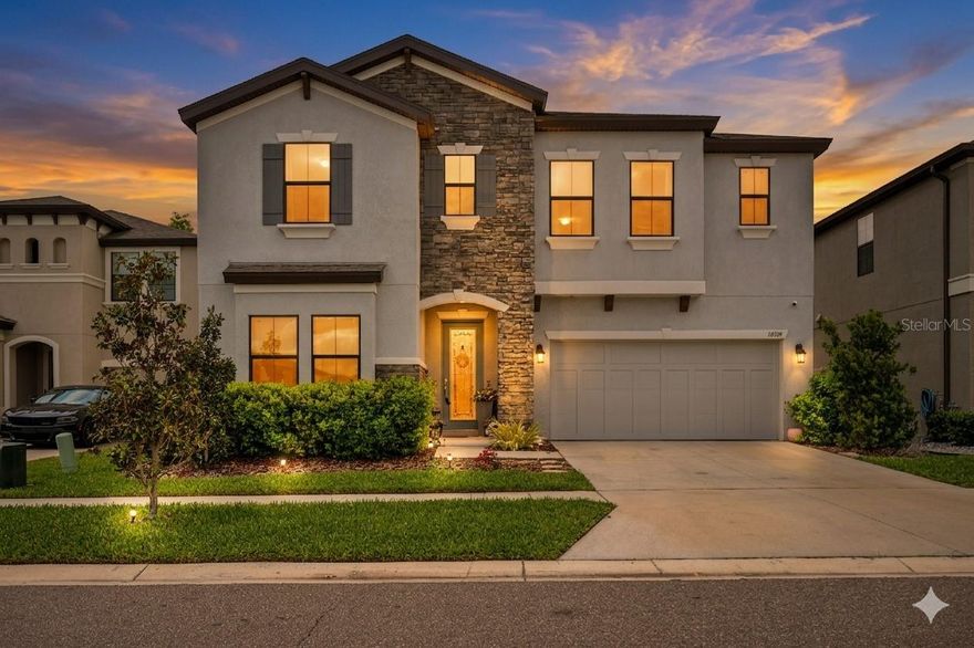 Beyond the manicured entrance of the Hawkstone community, where the natural beauty of Lithia meets master-planned neighborhood, stands a residence that tells a story of elegant design and elevated comfort. From the custom landscaping adorned with Rainforest White stone to the elegant glass-inlay front door, this home invites you into a lifestyle defined by sophistication. A Main Level Built for Connection. The story begins in the light-filled foyer, where Riverside LVP flooring guides you into the heart of the home. The "Pelican" floor plan unfolds with an effortless grace, centering on a gourmet kitchen that serves as the home’s true centerpiece. Unlike many standard builds, this kitchen is a chef’s sanctuary, featuring Calacatta Novello quartz, built-in appliances, and a designer hood over a custom backsplash. Whether you are hosting a formal holiday dinner in the dedicated dining room or enjoying a quiet morning in the sun-drenched café, the open-concept grand room keeps the conversation flowing. For those seeking flexibility, the main level also hosts a secluded secondary bedroom and full bath—perfect for a private guest wing or a quiet home office. Your Private Sanctuary Awaits. Retreat upstairs to find a layout designed for the modern family. A versatile bonus room acts as a central gallery, connecting three spacious secondary bedrooms and a convenient second-floor laundry suite. The Owner’s Retreat is a masterpiece of privacy. Tucked away at the rear of the home, it offers a peaceful vista of the grounds. The en-suite bath mirrors the luxury of a high-end spa, complete with a soaking tub, a sleek walk-in shower, and an oversized walk-in closet that accommodates even the most extensive wardrobes. Open the large glass doors to the beautiful lanai and discover a $10,000 professionally extended patio. It is the perfect stage for evening gatherings under the stars or a serene spot for your morning coffee. With a whole-home water softener and thoughtful upgrades integrated throughout, every detail has been handled so you can simply move in and begin your next chapter. A Community Connected to Nature Life in Hawkstone extends far beyond your property line. Here, your weekends are defined by choice: Explore the 969-acre Triple Creek Nature Preserve, located just two miles from your door. Take advantage of the nearby Triple Creek BMX or the community’s own resort-style amenities. Enjoy the peace of mind that comes with proximity to top-rated Lithia schools and easy access to I-75. This isn't just a house; it is a meticulously curated backdrop for your life’s best moments. Experience the Hawkstone lifestyle for yourself today!