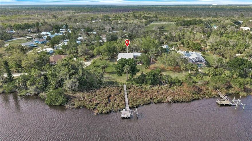 Tucked away on a peaceful oversized lot in Punta Gorda, this charming waterfront retreat offers the perfect blend of privacy, space, and Florida outdoor living. Set on nearly half an acre, this 3-bedroom, 3-bath home features over 2,200 square feet of living space and a layout designed for both comfort and entertaining.

Step inside to find a warm and inviting interior highlighted by a cozy living room fireplace and generous living areas including a spiral staircase leading to the second floor bonus room with stunning views of the water. The true showstopper is the expansive screened-in lanai and private pool, creating the ideal setting to relax, entertain, and enjoy year-round sunshine.

Out back, take in serene water views and direct access via your private dock and lift that is perfect for kayaking, fishing, or simply soaking in the natural surroundings. The property offers a rare combination of space and tranquility, all while being just a short drive to downtown Punta Gorda, dining, shopping, and I-75 access.

With no HOA fees and plenty of room to spread out, this is Florida living at its finest, whether you're looking for a full-time residence, seasonal escape, or investment opportunity.