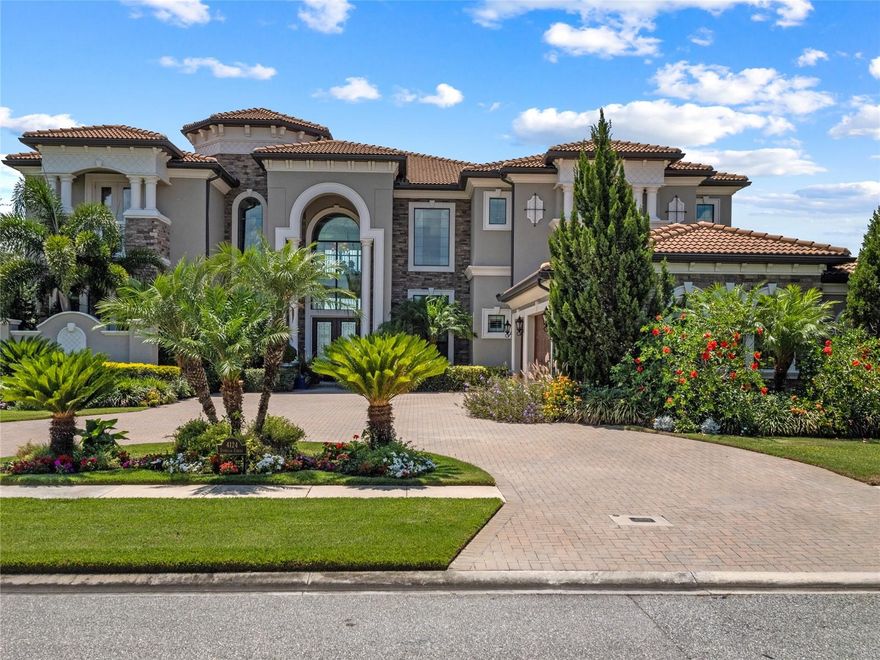 Elegant Water Front Pool Estate in Casabella, a Luxury Gated Community in private upscale Windermere. This impressive Villa Lago model has 6 Bedrooms, 6 Baths, and 2 half Baths and was built for Entertaining. As you enter the home, you are instantly greeted with an impressive Formal Living Room with expansive 24 ft ceilings and 2 Floors of windows, overlooking the sparkling saltwater heated swimming pool, spa, and waterfall feature. This majestic home offers the finest quality throughout, with uncompromising attention to detail, finish, form, and function. Boasting coffered ceilings throughout. Open Floor. European architecture with contemporary design. First-floor Master Bedroom with ensuite Spa style Bathroom, 2 separate water closets, and an enormous 18-foot walk-in closet. Second Floor Master Bedroom with ensuite Bathroom. Gourmet kitchen with oversized island with top-of-the-line Jenn Air appliances and granite countertops. Hosting guests will be effortless with this spacious estate which includes a wine cellar, wet bar, gourmet kitchen, butlers pantry, and a private gym. Expansive Private Backyard Oasis, Stone Paver Patio, Resort-style Pool, automatic retractable shades allow you to control your level of privacy and keep pests separately on the Lanai/Summer Kitchen. Located facing east-west direction w/breathtaking sunsets and serene water views can be enjoyed from almost any location within the property. The pond borders two sides of the house without any neighbors to the left. 3 Car Garage, Natural lighting throughout. Electric Vehicle Charging Station. The community is centrally located near great schools, shopping, highways and great golfing.