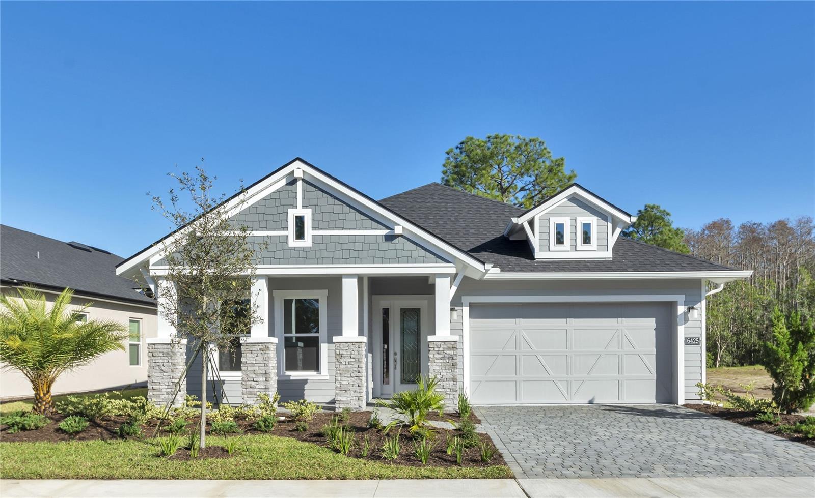 Move-in Ready! Welcome to this stunning new construction home, built by ICI Homes, in the gated Woodhaven Spruce Lake community! This home features a welcoming covered front porch and an extended covered lanai that overlooks private lake and preserve, Saguaro Ct. is a dead end street with cul-de-sac. The deluxe kitchen is a chef’s dream with white, soft-close cabinetry, upgraded quartz countertops, and stainless-steel GE appliances, including a dishwasher, in-wall oven, microwave, hood vent, a 32" electric cooktop and French door refrigerator, GE front load washer and dryer are also included. The large island faces the spacious, open-concept living room, and the adjacent dining room is perfect for entertaining, luxury vinyl floors finish this home off with a look of luxury that can’t be overlooked. The home showcases soaring 12-ft ceilings in the main living areas, creating a bright and airy atmosphere. The oversized rear lanai faces the private lake and is pre-plumbed for a summer kitchen. The 2-car garage has epoxy-coated floors, and the home comes equipped with Smart Home technology and energy-efficient features. As a bonus, the community offers a pool, playground, and scenic walking trails. Located within the highly rated Spruce Creek School district, this move-in ready home blends luxury, convenience, and comfort in an ideal location.