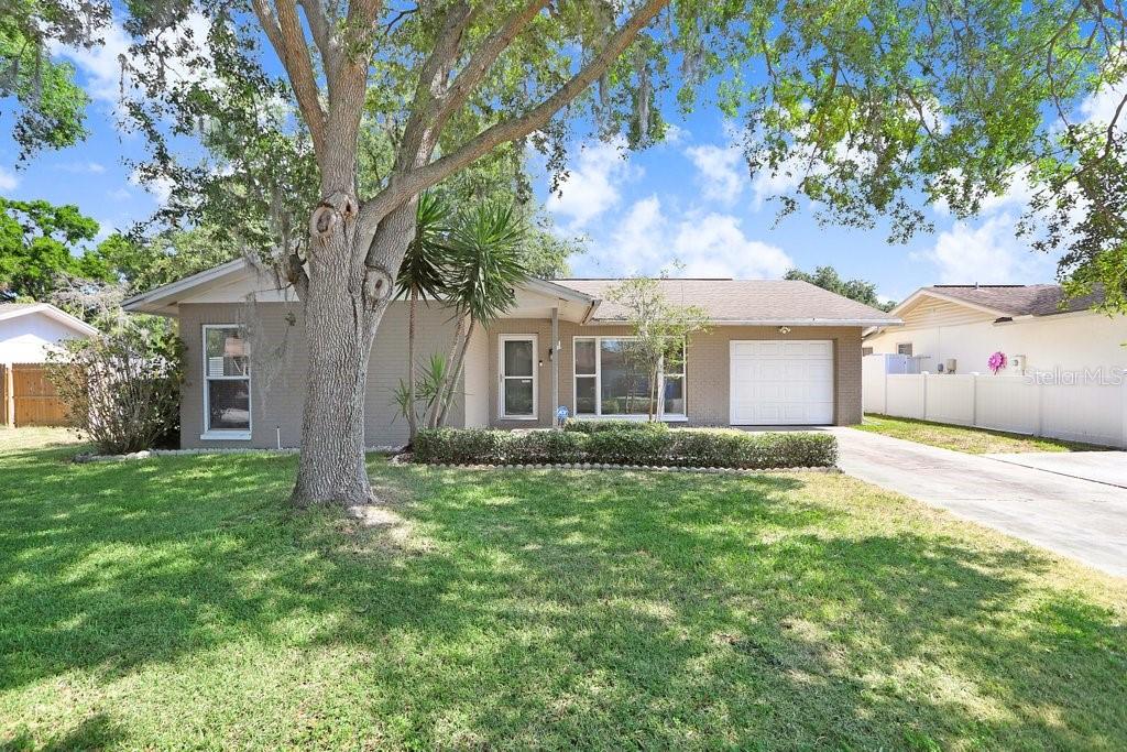 Charming Carrollwood Rental Home! Located in desirable Carrollwood Meadows, this centrally located 3-bedroom, 2-bath home offers 1,428 sq. ft. of comfortable living space with an additional flex room/den, spacious screened-in porch, 1-car garage, and oversized parking pad. Inside, you'll find a bright and airy family room with vaulted ceilings and a large front-facing picture window. The galley-style kitchen includes a generous dining nook, breakfast bar, wood cabinetry, granite countertops, and stainless steel appliances, plus a window overlooking the backyard. A convenient pass-through leads to a mudroom area, indoor laundry closet, and garage access. Washer and dryer are included in the lease. The primary bedroom features a double closet and updated en-suite bathroom. Two additional bedrooms share a full hall bath. Enjoy Florida living on the expansive screened porch overlooking a large, fenced backyard with beautiful mature oak trees. Lawn care is included. Dogs will be considered on a case-by-case basis with a $350 non-refundable pet deposit. No cats, please. Residents of Carrollwood Meadows enjoy access to a Hillsborough County park with tennis and basketball courts, a playground, open field, and covered pavilions. Available for immediate occupancy.