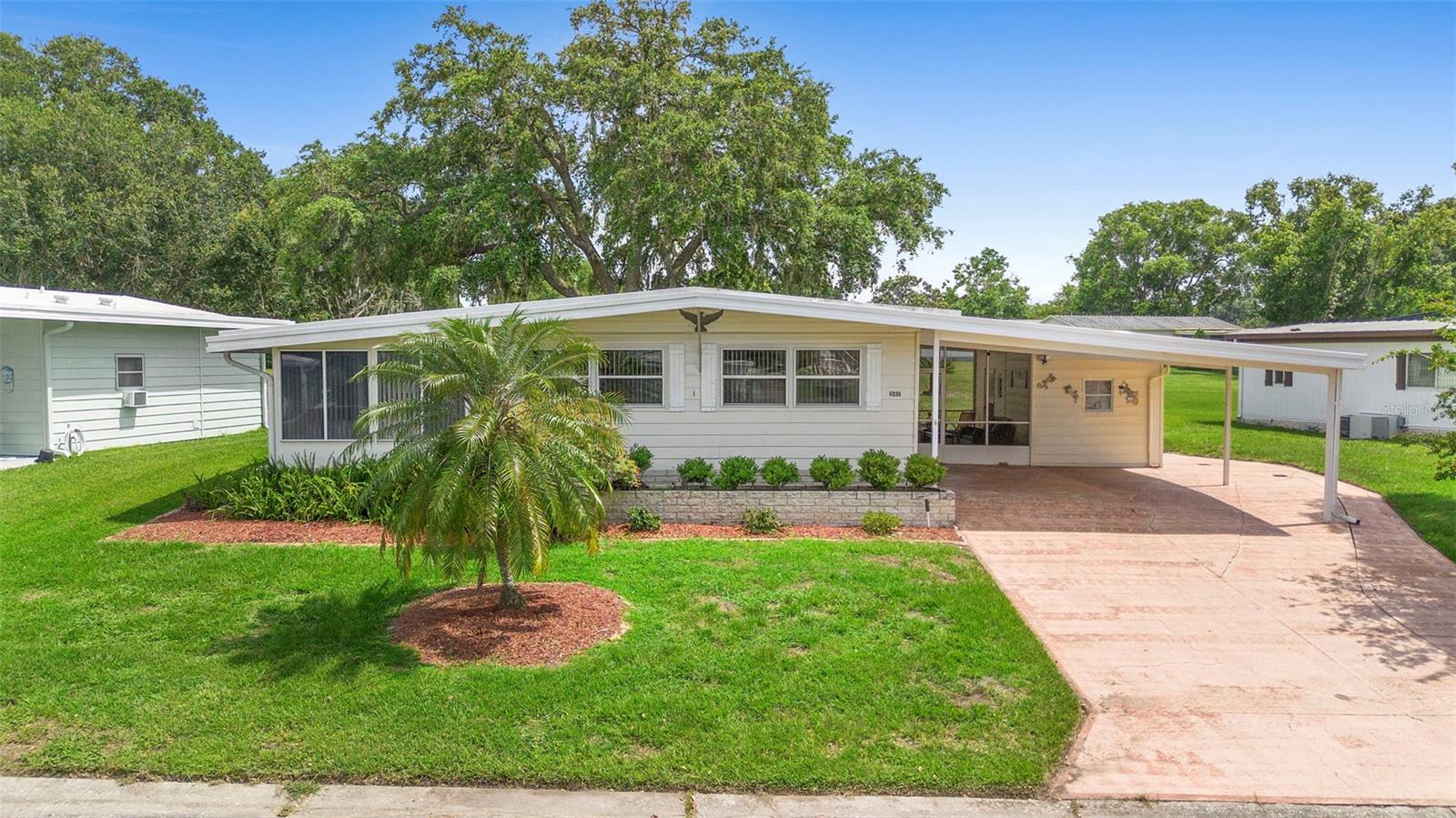 Welcome to this beautifully maintained 2-bedroom, 2-bathroom home in the highly desirable 55+ gated community of Zellwood Station. Ideally located on Black Oak Lane, this gem is just steps from the main heated saltwater pool with hot tub, this is just one of the four community pools and a wide array of amenities, including golf, pickleball, clubhouse, water exercise, line dancing classes and our own Whistle Stop Restaurant and Lounge with banquet facilities, and so much more! There is always something to do here! This home features spacious indoor living, an enclosed Florida room, and a separate lanai – perfect for enjoying the Florida lifestyle. The indoor laundry room and bonus storage room provide added convenience, while the golf cart garage and storage unit offer all the space you need for hobbies and equipment. Recent upgrades include: New Whirlpool stainless steel refrigerator, New Admiral washer and dryer, New Rheem water softener with filter, Samsung dishwasher (3 years old), 2 new blower motors in central A/C unit, A/C system inspected and serviced yearly, Both bathrooms have been updated with: New wooden medicine cabinets in one bathroom, High-rise toilets, New faucets, Grab bars for safety in one bathroom. Whether you're looking for a year-round residence or a seasonal escape, this home delivers comfort, convenience, and value in one of Central Florida’s premier active adult communities. Don't miss your chance to enjoy resort-style living with low maintenance in Zellwood Station!