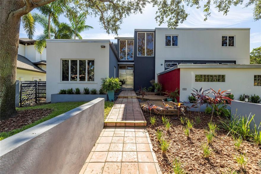 Designed by renowned Architect William Harvard Jr and built in 2005, this waterfront modern marvel boasts a beautiful layout and a wonderful view in a highly desirable location of Snell Isle. This home was built like a bunker, and was certainly tested during the recent storms, with no damage or interior flooding. The home sits above the flood plane, and the exterior walls are concrete block with filled cells, and with structural steel studs. Interior walls are also concrete block with prestressed concrete planks for ceiling and roof support. The floor construction is concrete under the beautiful hardwoods. The home also features a new roof in 2024, hurricane windows and doors throughout, and a whole house generator so you don't lose power in any storm. Beyond the best construction, this is an artist's home, where natural light fills the spacious rooms, and provides grand wall space with 10' ceilings on the first floor. Enter through the custom metal front doors into a two story foyer. To the left is a beautiful formal living room and large hall closet that could be turned into a butler's pantry or wet bar. The large first floor den also features a full bath, and could be used as a downstairs primary or guest room. For the ultimate entertainer, the formal dining room connects to the chef's kitchen, featuring a professional 6 burner Thermador range and large eat-at island with custom red quartz. The cozy family room features a gas fireplace and inlaid wood floors. Every living space features french doors that open to the Spanish tiled porch that spans the width of the home, the ideal place to enjoy the morning air or evening beauty of Coffee Pot Bayou. When it is time to retire for the night, take the elevator to the second floor, featuring 8' ceilings, wood and carpet floors. Three bedrooms upstairs all feature en-suite bathrooms with cast iron tubs, custom vanities and countertops, and waterfront views. Down the hall is a large laundry room with great storage. The master suite features a large walk-in closet and large bathroom with shower, garden tub, toilet room, dressing area, and custom double vanity. All bedrooms on the second floor have doors to two covered porches, where you can enjoy a morning coffee overlooking your private yard and updated dock on the bayou. The dock was rebuilt in 2024 and has both a boat lift and jet ski lift. A massive three car garage has high ceilings and bonus storage areas, and can accommodate a car lover's lifts for multiple vehicles and toys. Just minutes to downtown St Petersburg, this beautiful Snell Isle home was built to last, and its modern design make it timeless. Make your private showing appointment today!