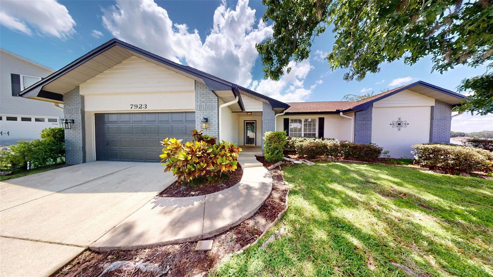 Exquisite three bedroom, two bath split plan home, two car garage, home was freshly painted inside and out (2024), & many modern upgrades. All this on a fenced in backyard on a 1/2 acre lot. Walk up to the front door & enter to foyer leading to both to the family room or right to the formal living room with large window overlooking the beautifully landscaped front yard, then continue to the formal dining room with modern chandelier all three room boost high ceilings & real wood flooring. Bonus room (enclosed porch) with large window overlooks the screened in lanai & pool, Bonus room can you accessed through sliding doors located in the dining room & also from the family room. This bonus room also has a pass-through window from the kitchen. Now I saved the best for last, swim in this beautiful salt water heated pool that has two shallow ends perfect for playing water sports like volley ball and the lanai has a HUGE storage closet to store all you pool toys. All this and lawn & pool maintaince are included, so sit back, relax and enjoy! This is perfect for entertaining & will not disappoint!
