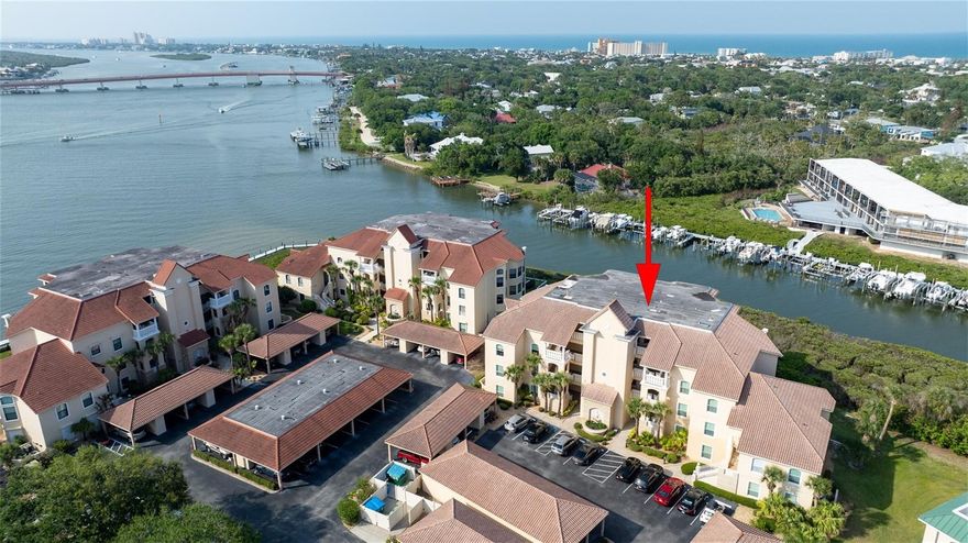 Step into a serene waterfront sanctuary with this beautifully remodeled & tastefully furnished 2BR/2BA Bouchelle condo situated on the 2nd floor which overlooks Callalisa Creek & has fantastic views of the Indian River! Enjoy peaceful sunrises & sunsets & watch the boating action from your spacious waterfront screened balcony. Remodeling in 2023 included new top of the line custom kitchen & bath white cabinets & soft close drawers & beautiful designer quartz counter tops. A built in desk & more cabinets were added in the kitchen & the utility closet for more storage. Gourmet kitchen features attractive tiled backsplash & under cabinet lighting which add to the ambience of this stunning condo! Flowing seamlessly into the dining & living areas, complete with counter bar seating. The master suite is a haven of comfort, featuring direct access to the lanai and a luxurious en-suite bathroom offering a large walk-in closet, linen closet, double vanity, and a separate shower and garden tub. Crafted with full concrete construction, tranquility and peace abound within these walls. For added convenience, a carport (#2) is included, with your private storage closet, great for storing bikes, fishing equipment & beach gear! Kitchen features newer SS appliances & the washer dryer & HVAC were replaced in 2017. Bouchelle Island presents an array of amenities and activities, including an 18-hole pitch and putt golf course, tennis and pickleball courts, two swimming pools & spas, a fitness room, clubhouse with gas grill and kitchen. Please see the attached sellers disclosure for more upgrades! Enjoy the access to the brand new 1/2 mile riverfront board walk, with both wet and dry boat slips & private boat ramp into the Indian River. Relax & enjoy the riverfront tiki huts, firepits, BBQ grills, tables & chairs at the west end of the island. Situated conveniently close to shopping and dining options, including Flagler Avenue and Canal Street, as well as easy beach access, Bouchelle Island provides the lifestyle you deserve.
