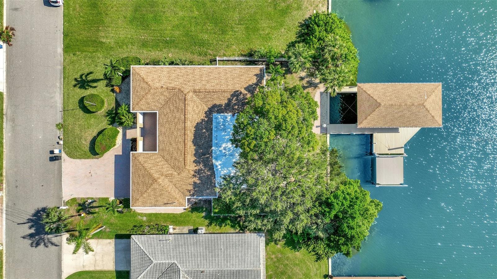 Welcome to exclusive Island Estates !! One or more photo(s) has been virtually staged. AMAZING VALUE ! 25K lb with a COVERED BOAT LIFT! This property was damaged during Hurricane Helene and has been mediated for your convenience. Bring your Contractor, and create the home of your dreams! This location is where sophistication meets coastal charm and every day is a celebration of the waterfront lifestyle! Bring your boats to this waterfront home, offering western exposure in the backyard, deep water, wide canal and quick access to the Gulf of Mexico! Upon arrival, you will be enchanted by the oversized paver-laid entrance and private patio to enjoy your quiet mornings. As you enter, you are immediately captivated by the immediate view of the water and oversized 25K boat lift with a covered boat house. Large glass windows provide a panoramic set of views and relaxation that permeates every room in the house. Comprising of three bedrooms and two baths, this residence offers popular french-style doors throughout the home, beckoning towards the water, ideal for hosting family and friends. Meanwhile, the family room provides wide open space for cozy nights in front of the TV. When you head outside, you are immediately captivated by the beautiful view Deep water to accommodate larger boats and access to beautiful waters of the Clearwater Intracoastal or open water of the Gulf of Mexico. Island Estates stands as an idyllic community of 550 single-family homes and offers its residents an enclave of amenities, including charming shops, convenient banks, vibrant bars, and exquisite restaurants, ensuring a lifestyle of utmost comfort and convenience. Minutes away from Clearwater Beach, you are granted easy access to pristine sandy shores and sparkling turquoise waters. Schedule an appointment today and come live in tropical paradise!