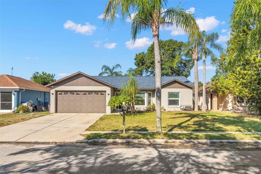 Wow! Look no further! Located in a desirable location, this beautiful 2 bedroom, 2 bath pool home offers 1,093 sq. ft. of living space in a peaceful, established neighborhood with no HOA and NO FLOOD INSURANCE REQUIRED!  Enjoy your own private oasis with a sparkling screened in pool- resurfaced with pebble tech in 2018 with an upgraded pool pump, LED lights, and features a 5ft. custom tile manta ray in the center. Expansive decking area is perfect for relaxing or entertaining.  Enter the inside through the brand new front door (2025) and experience the quiet and safety from the Cat 5 hurricane impact resistant windows and sliders (2018). Additional major updates include AC (2022), roof with solar attic fan (2024), Samsung washer and dryer (2017), carpet (2015). Comfortable airy floor plan with a bright kitchen with Frigidaire appliances and split bedrooms.  Spacious 2 car garage.  This move in ready home provides quality updates and minutes from shopping, schools (walking distance to Anclote Elementary) restaurants, beautiful Gulf beaches, 2 international airports, completely renovated Centennial Park, newly renovated library where they have classes for all ages, newly renovated Main St in New Port Richey with Sims Park.  Come look today!