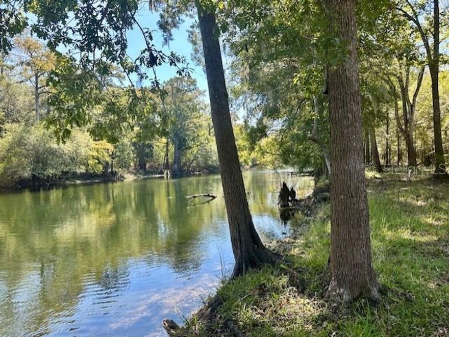 BEAUTIFUL RIVERFRONT PROPERTY ON THE SANTA FE! This gorgeous piece boasts over 8 acres with 450 FEET of water front access! This property consists of two lots, one 2.78 acres and the other 5.48, totaling 8.26 acres for you to enjoy! Home to tons of native Florida wildlife and vegetation, this property is a true nature lovers paradise. Come build your dream home, set up your new mobile home, or enjoy turning this into the perfect weekend getaway! The possibilities are endless! Well and septic. Walk down the easily walkable river bank to sit by the river and read a book, throw out a fishing line, or launch your kayak and go for a paddle. There is nothing like the remarkable Santa Fe river, where you can also discover numerous natural springs such as Gilchrist Blue, Hornsby, Lily, Poe, Ginnie, and Rum Island. Several public boat ramps also nearby. Easily accessible year round by any vehicle on a maintained road. Less than an hour to nearby Gainesville or Lake City for work, local colleges, and hospital systems including UF Health, HCA and the VA. Gilchrist County is known for its low property taxes and "A" rated schools. Call today to make this one-of-a-kind property yours!