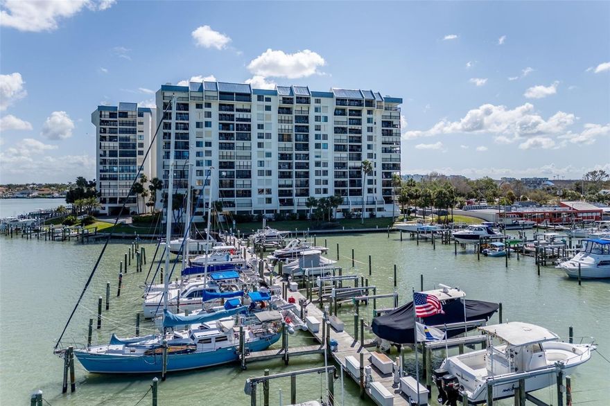 STUNNING WATERFRONT CONDO with BREATHTAKING VIEWS of the Intracoastal, the GULF OF MEXICO, and NIGHTLY SUNSETS! Welcome to the Yacht & Tennis Club of St. Pete Beach—where COASTAL LUXURY meets RESORT-STYLE AMENITIES! This beautifully updated 2BR/2BA condo in the Courageous Building offers panoramic 5th-floor views stretching west toward the Gulf. Watch boats drift by and sunsets light up the sky—all from your private balcony. Inside, the open kitchen features solid wood cabinets, granite countertops, a center island, and a charming breakfast nook with a view. The layout flows into the dining and living space—perfect for entertaining or unwinding after a day at the beach. Enjoy luxury vinyl flooring, storm shutters, and a bright primary suite with balcony access, a walk-in closet, and a spacious en-suite. The guest suite offers comfort and privacy with its own walk-in shower. In-unit washer/dryer included. This gated community offers it all: heated waterfront pool, hot tub, saunas, clubhouse, fitness center, tennis & pickleball courts, and a marina—a dream for water lovers. Walk to Treasure Island Beach and close to restaurants and shops, this is your chance to live the ULTIMATE COASTAL LIFESTYLE. DON’T MISS OUT—schedule your private tour today!