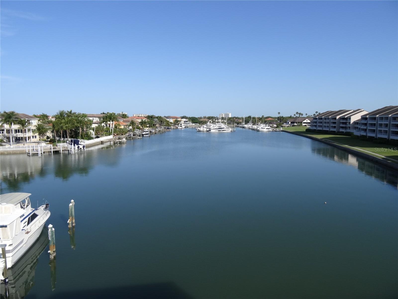Gorgeous water views await from this bright and open 1 bedroom, 1.5 bath condo in the highly desirable gated community of Pasadena Yacht & Country Club. From your top-floor retreat with soaring vaulted ceilings, you can watch dolphins play right outside your backyard. The home features tile floors throughout, an open layout filled with natural light, and the convenience of under-building parking. Enjoy resort-style living with a heated waterfront pool and the option to lease a boat slip for easy access to the bay. This condo combines comfort, security, and a true Florida lifestyle—all just minutes from Gulf beaches, shopping, and dining.